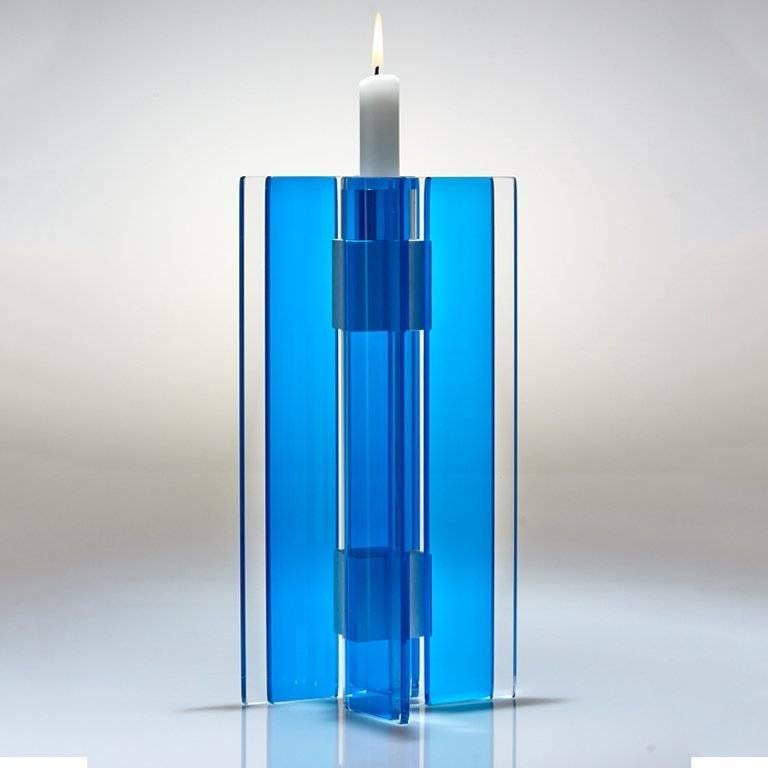 This polished glass candleholder is designed by world renowned glass artist, Sidney Hutter. With 40 years of experience in the contemporary glass and Fine art world, Sidney now creates illuminated designs for the home. Create a centrepiece or add