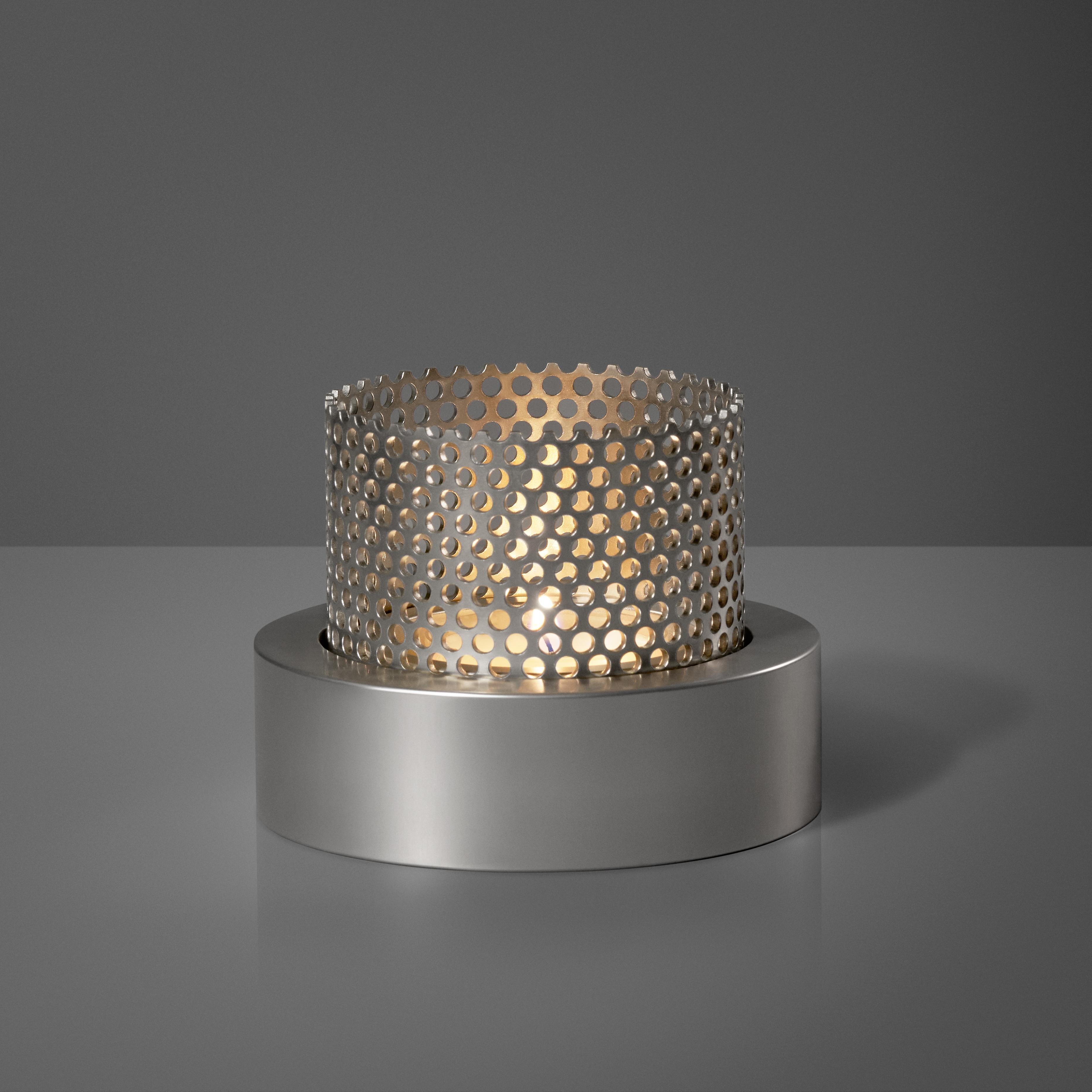 Perform is a solid metal candle holder in two parts, a CNC-milled base in aluminium and a perforated steel tube made in a factory in Sweden.

The light transmits through the perforated holes and creates light circles on the surroundings. The