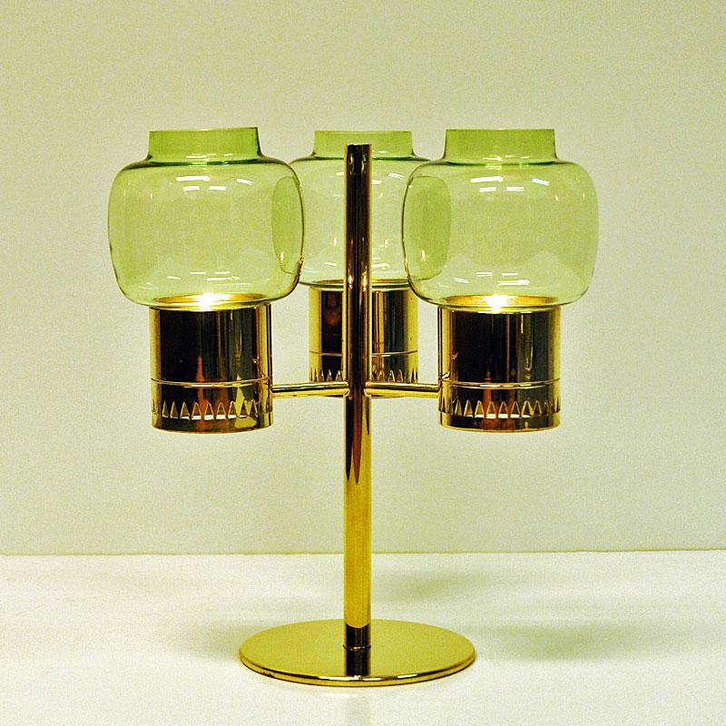 Brass and glass candleholder set with three lightgreen glassdomes model L67 designed by Hans-Agne Jacobsson, Markaryd Sweden. From circa 1950s. Base in brass. Measures: 22.5 cm H, 20cm D. For tealights.

Hans- Agne Jakobsson (1919-2009 ) was a