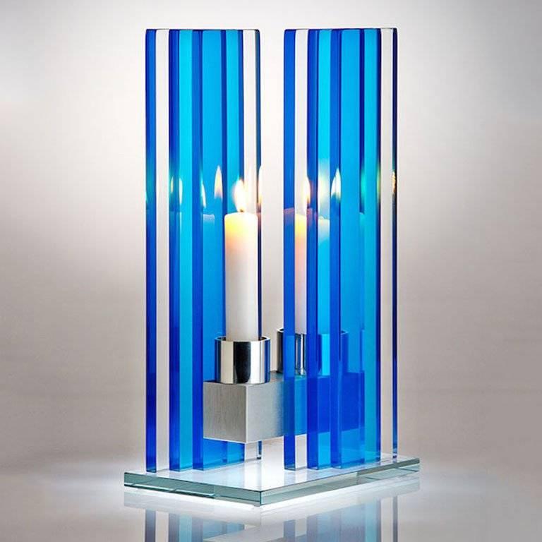 This polished glass, double candleholder from the Unified Light seriesis designed by world renowned glass artist, Sidney Hutter. With 40 years of experience in the contemporary glass and fine art world, Sidney now creates illuminated designs for the