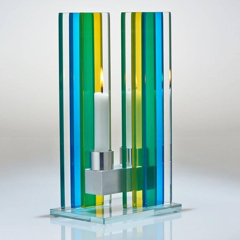 This polished glass, double candleholder from the Unified Light series is designed by world renowned glass artist, Sidney Hutter. With 40 years of experience in the contemporary glass and fine art world, Sidney now creates illuminated designs for