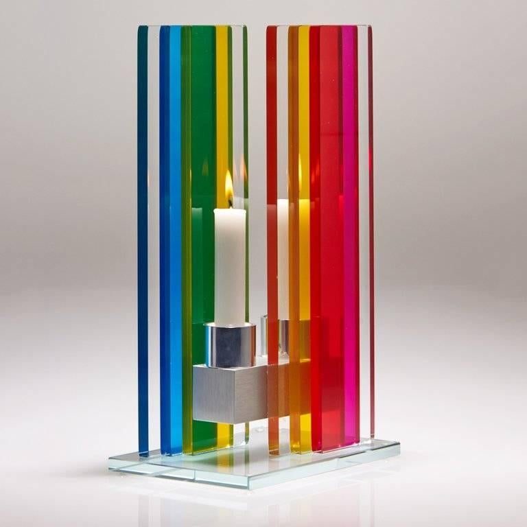 This polished glass, double candleholder is designed by world renowned glass artist, Sidney Hutter. With 40 years of experience in the contemporary glass and fine art world, Sidney now creates illuminated designs for the home. Create a centrepiece