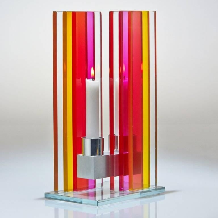 This polished glass, double candleholder from the Unified Light series is designed by world renowned glass artist, Sidney Hutter. With 40 years of experience in the contemporary glass and fine art world, Sidney now creates illuminated designs for