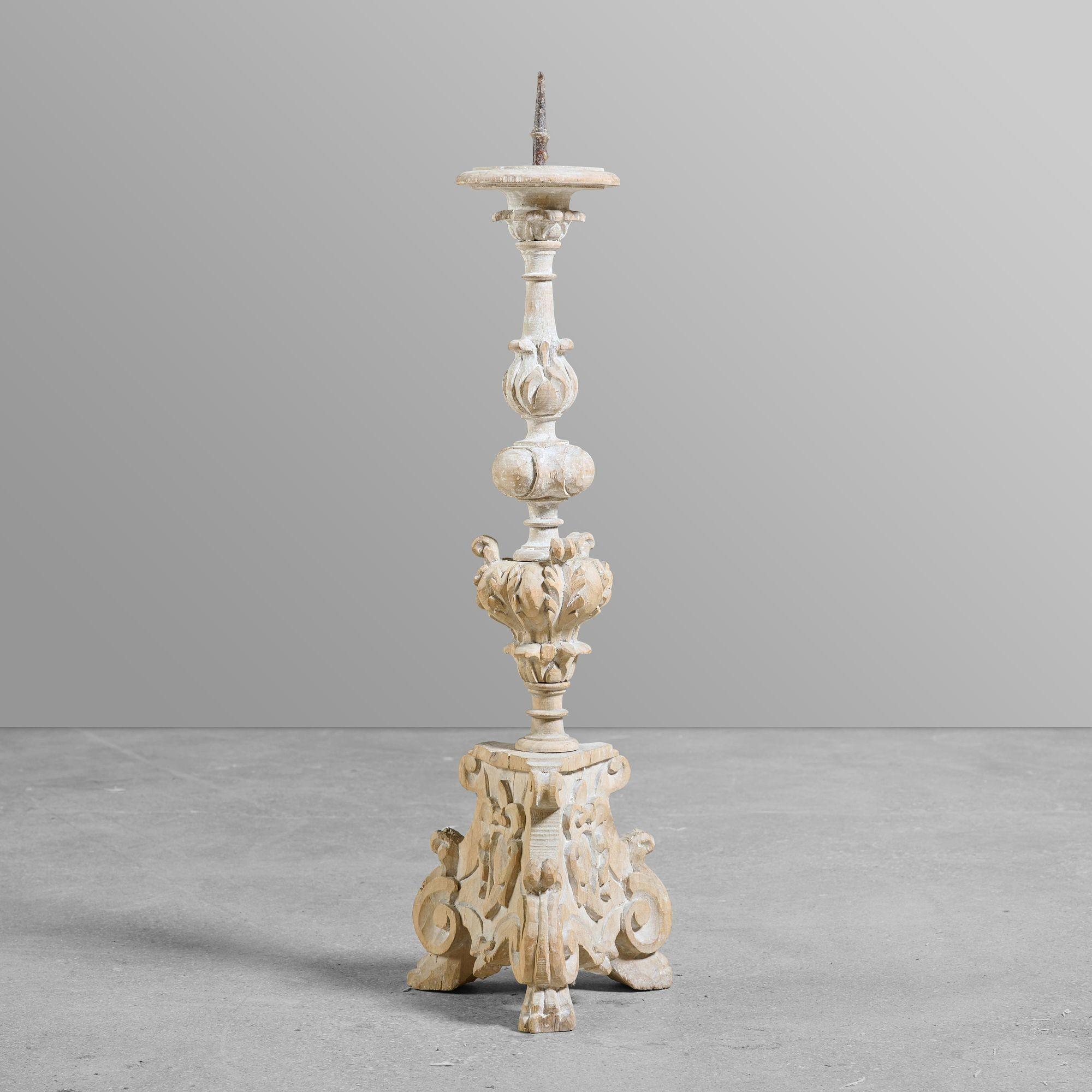 Set of three carved wood and gesso candlesticks with original iron spikes.


