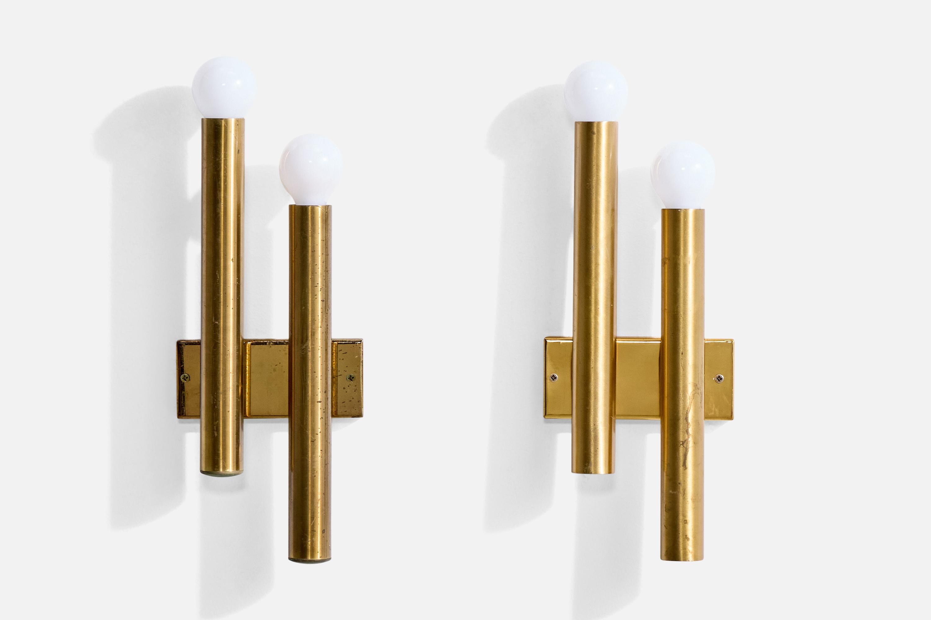 A pair of brass wall lights produced by Candle, Italy, c. 1960s.

Overall Dimensions (Inches): 13.25” H x 5.125” W x 2.1“ D

Back Plate Dimensions (Inches): 2.25” H x 5.125” W x .55” D

Bulb Specifications: E-14 frosted round

Number of Sockets (per