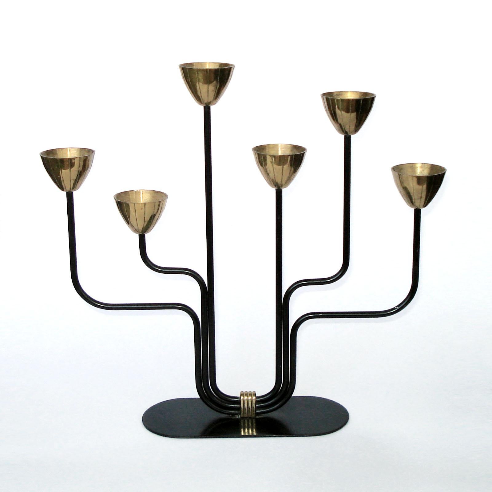 Brass and blackened metal candelabra for thin candles. Designed by Gunnar Ander for Ystad Metall Sweden. Stamped “Ystad Metall Made In Sweden”. Very good used condition, normal wear.
Dimensions: 28.5 x 6.5 x 26.5 cm.

