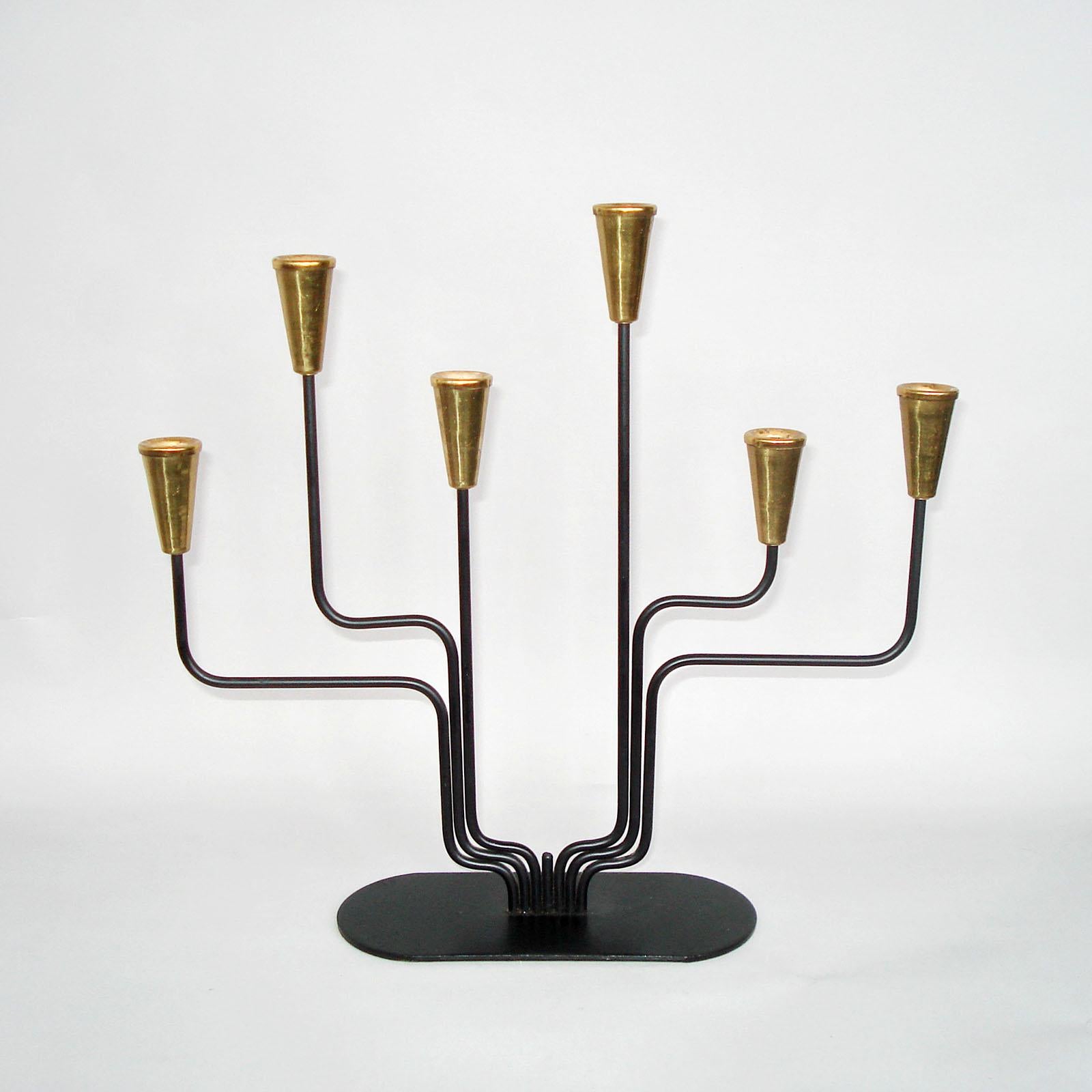 Brass and blackened metal candelabra for thin candles. Designed by Gunnar Ander for Ystad Metall Sweden. Stamped “Ystad Metall Made In Sweden”. Very good used condition, normal wear.
Dimensions: 28.5 x 6.5 x 26.5 cm.

 