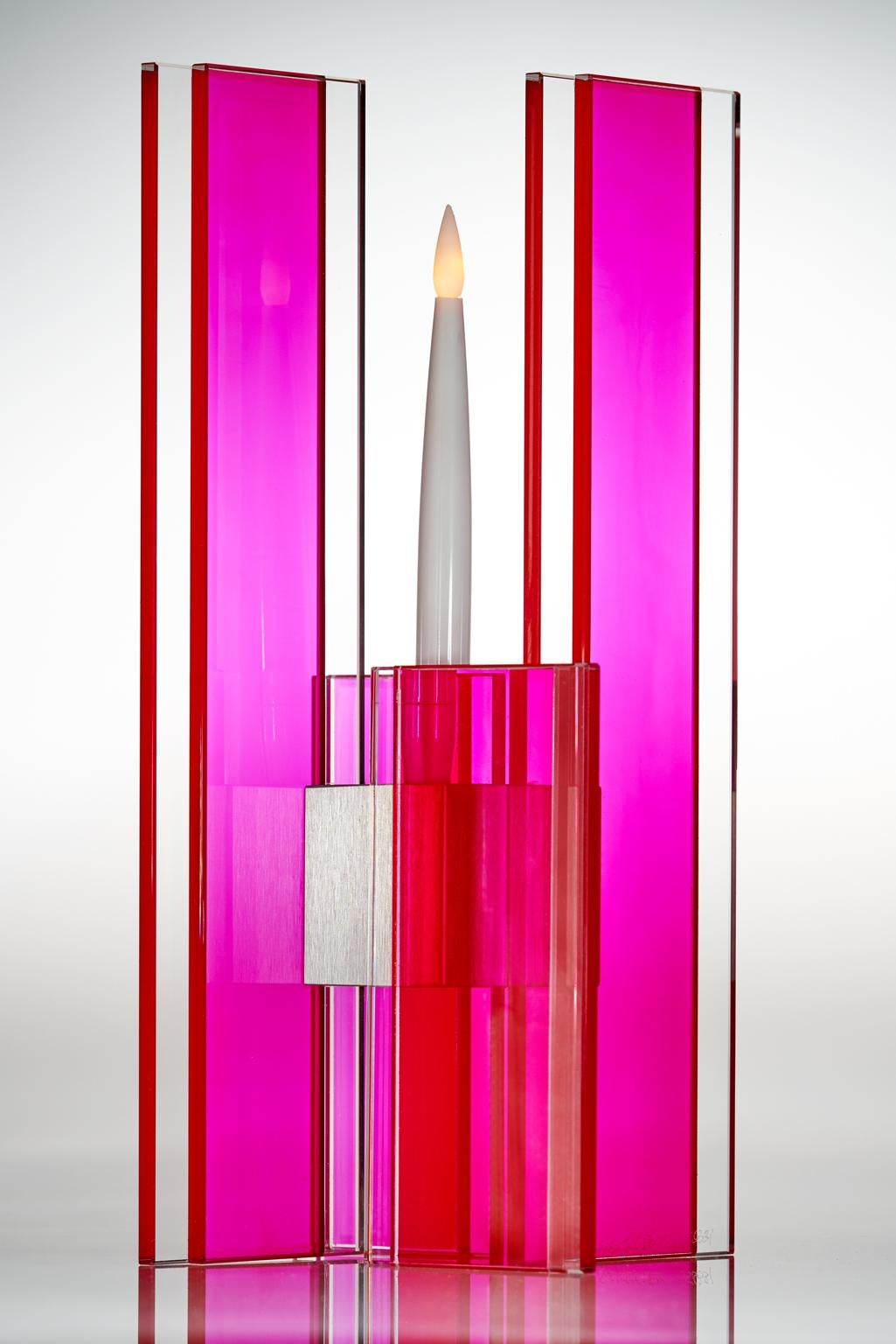 This polished glass candleholder from the Deco series is designed by world renowned glass artist, Sidney Hutter. With 40 years of experience in the contemporary glass and Fine art world, Sidney now creates illuminated designs for the home. Create a