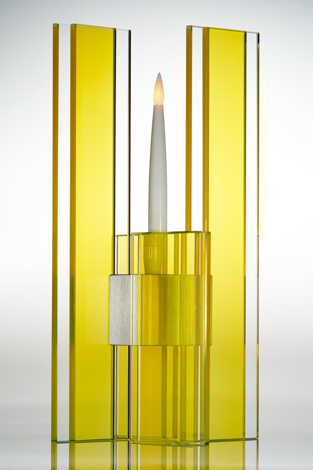 This polished glass candleholder from the Deco series is designed by world renowned glass artist, Sidney Hutter. With 40 years of experience in the contemporary glass and Fine art world, Sidney now creates illuminated designs for the home. Create a