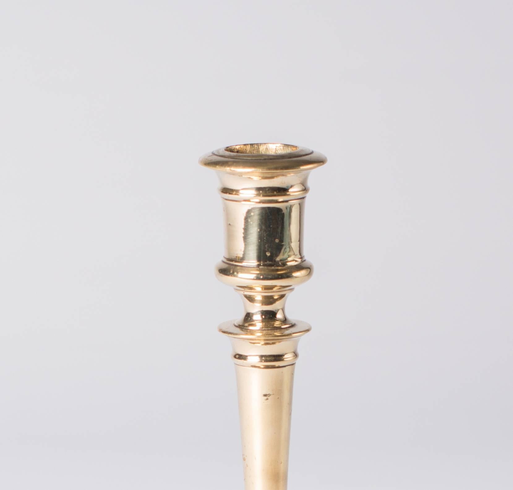 This Henry II (1547-1559) candlestick in bronze, is made in France. The candlestick has a low circular base with flat sunken centre. 
The inclusion of the circular lateral apertures in the socket, refer to the fact that this candlestick is of