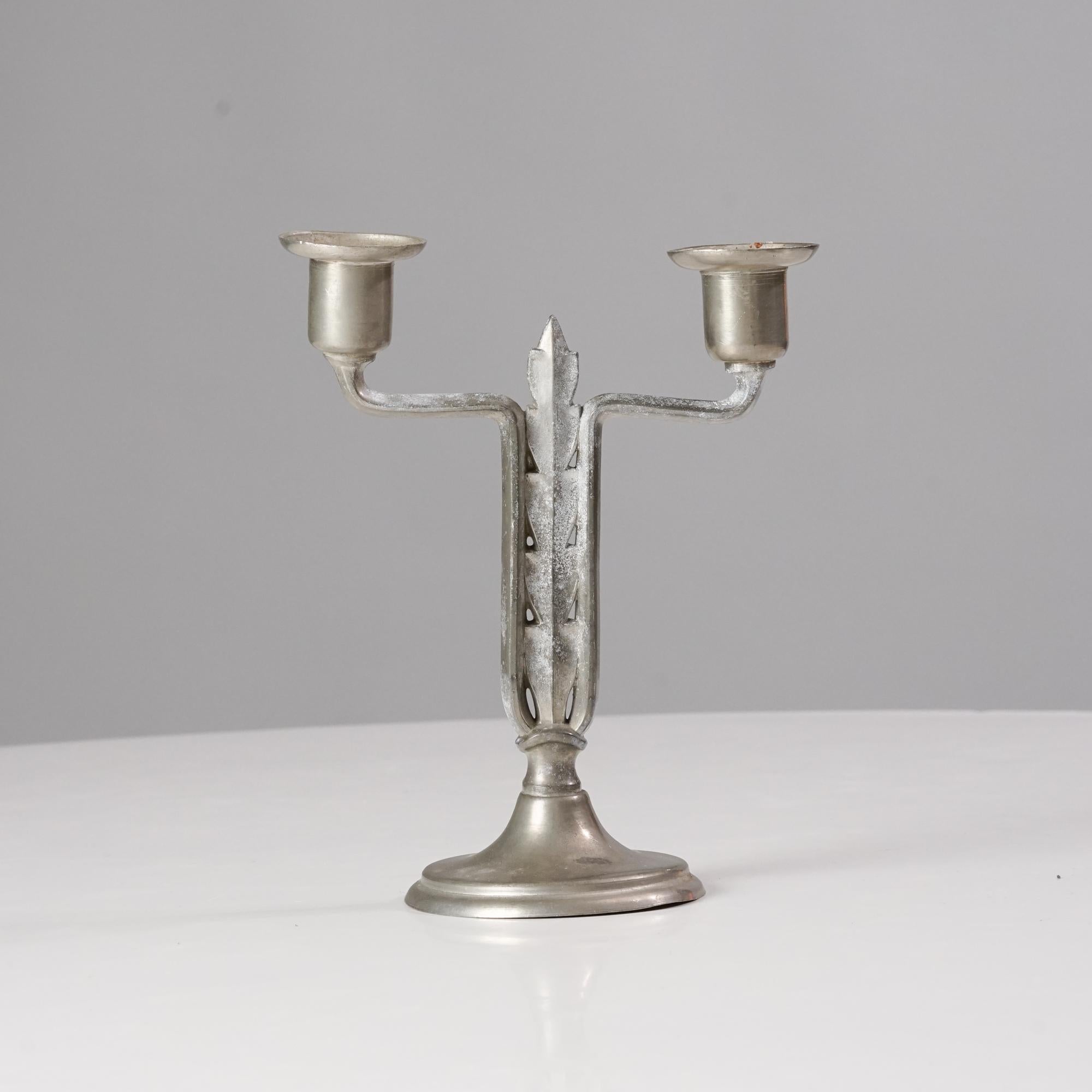 Candlestick by Paavo Tynell for Taito Oy from the 1920/1930s. Tin. Marked on the bottom. Good vintage condition, patina consistent with age and use. 
