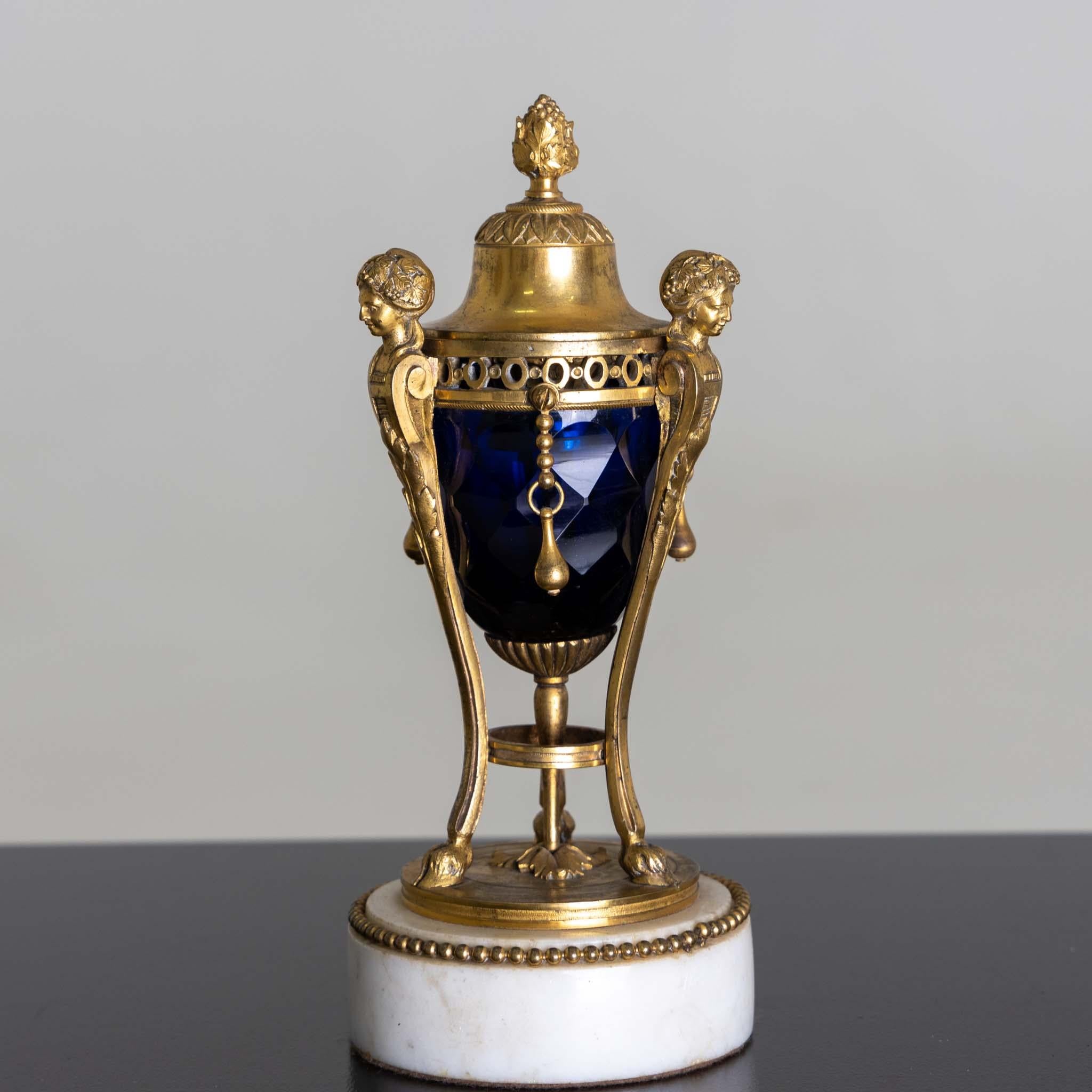 Small fire-gilt bronze candlestick with blue faceted crystal glass and marble base. Probably 