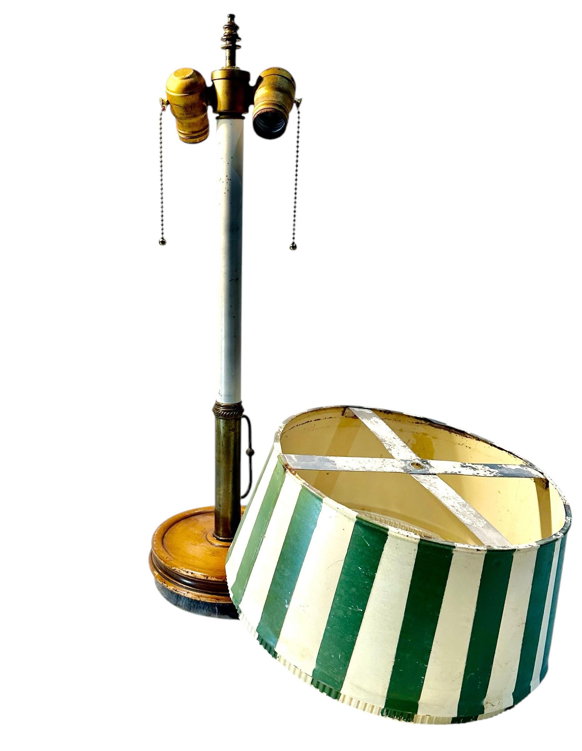 The wonderful candlestick lamp with tole shade, wood, and brass has two lights with two pull chains. The light sockets are actually very high quality as well as the lamp. The cord is eighty inches long. Circa 1960's.