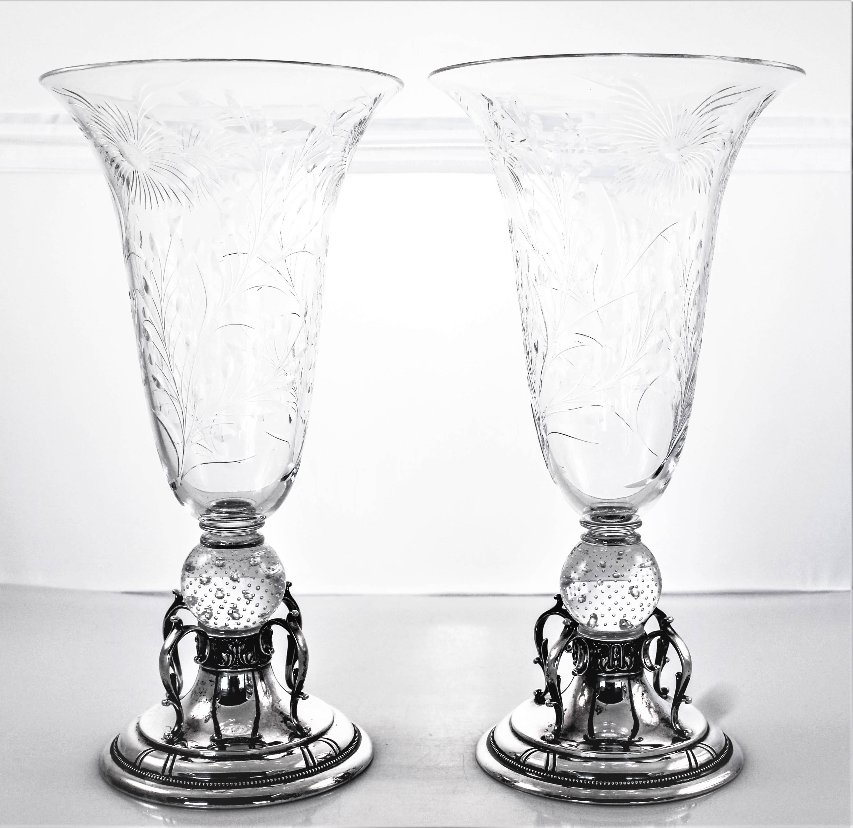 The magnificent combination of silver and crystal; Reed and Barton and Steuben teamed up to create these treasures. The base of the candlesticks are sterling with four curved designs that loop out onto an Art Deco design edge. The body is cut