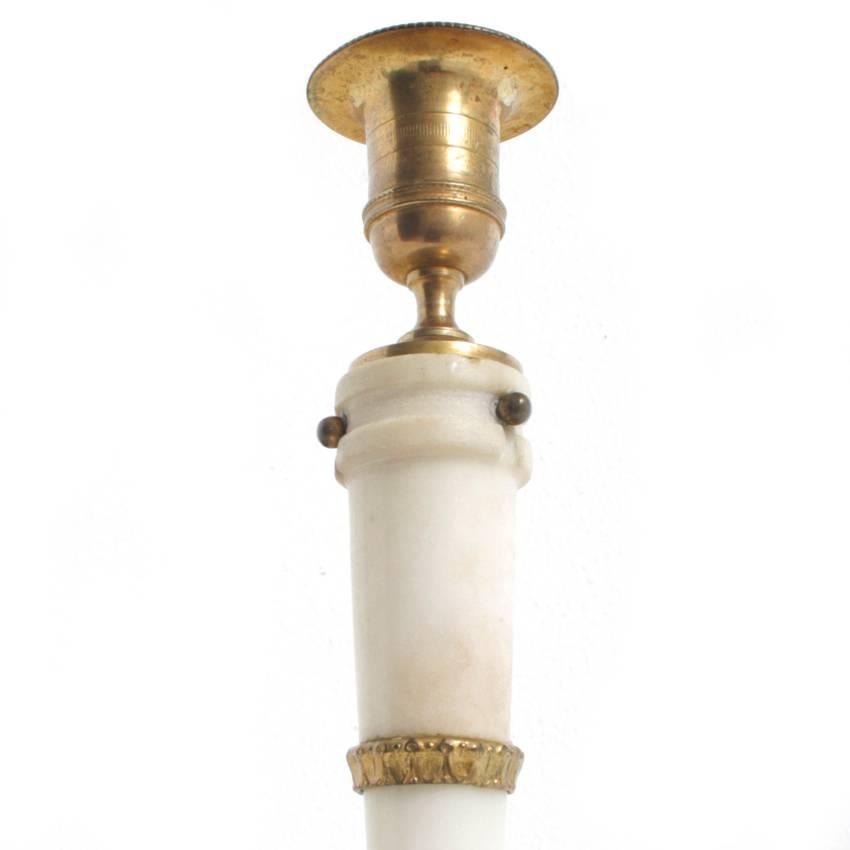 Pair of marble candlesticks from France of the first half of the 19th century. They stand on bronze paw feet, are decorated with acanthus leaves, and have vase-shaped nozzles.