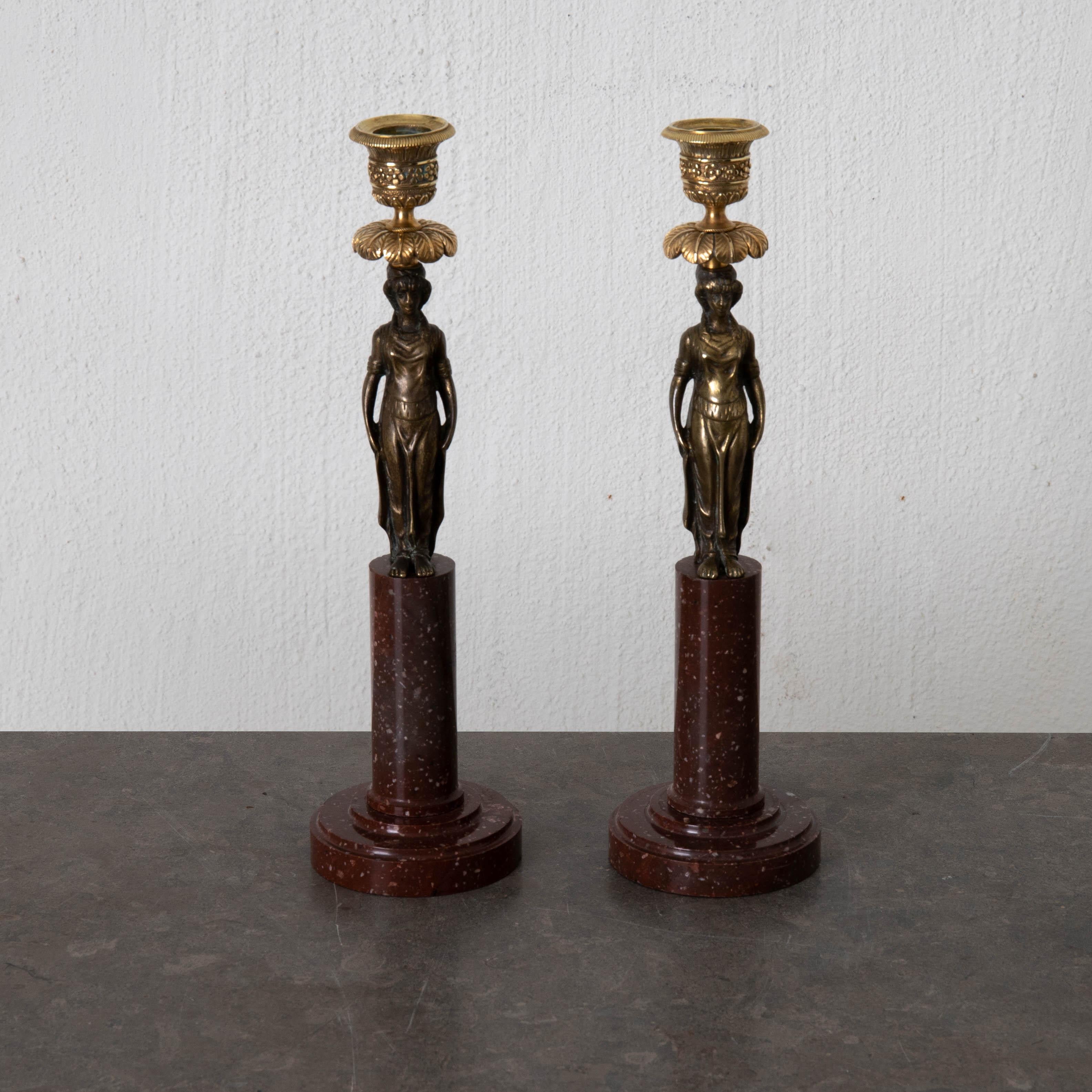 Candlesticks Gustavian pair Swedish 18th century red marble dark bronze Sweden. A pair of candlesticks made during the early 19th century in Sweden. Base in red marble with women shaped figurines in black patinated bronze and gilt bronze