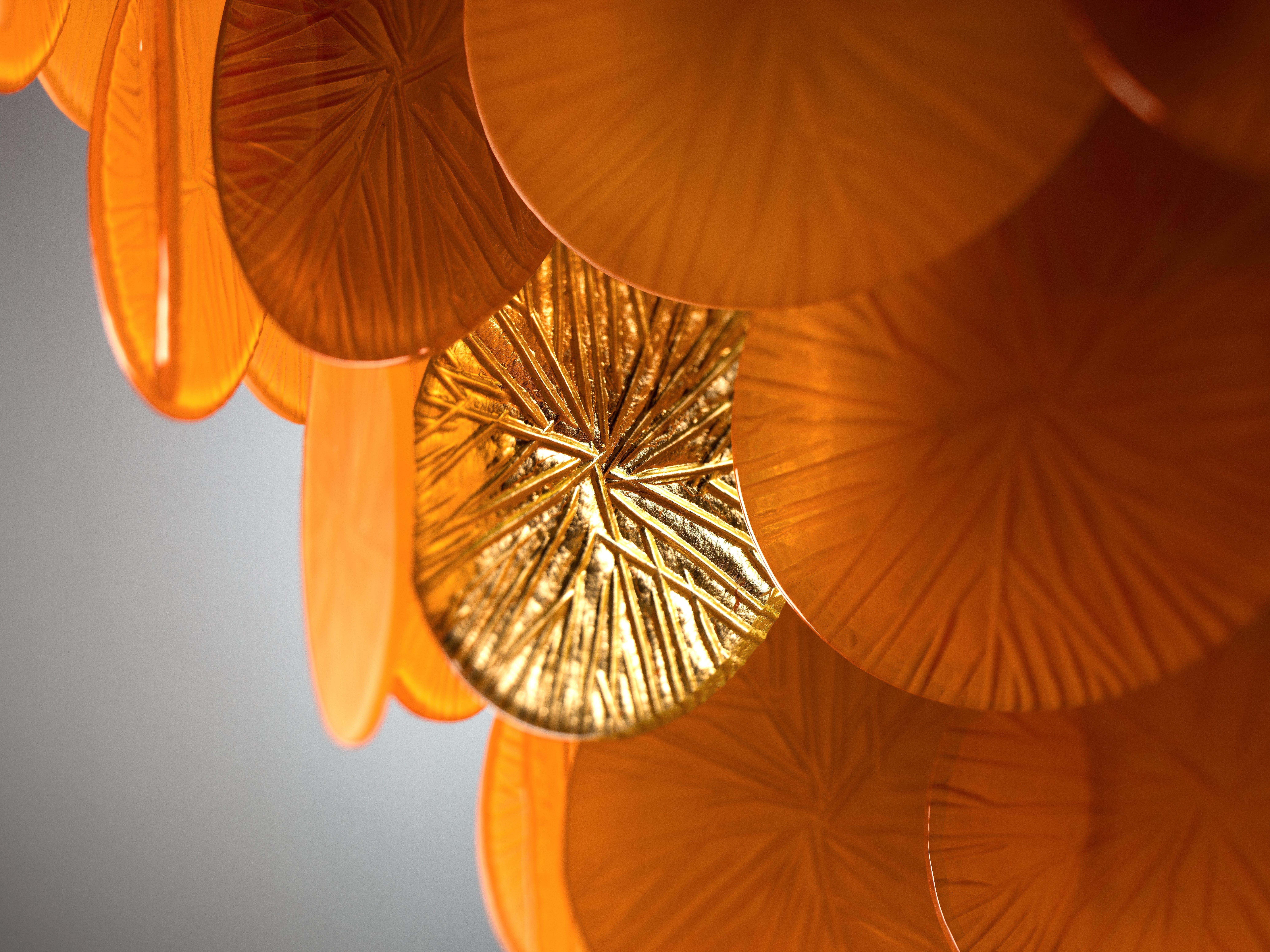 The Candy Chandelier – 12 Lights – Mango & Gold by Villari is a true celebration of artistic craftsmanship and radiant beauty. Entirely handmade in Murano glass, it features warm mango tones harmoniously combined with 24-carat gold-plated brass and