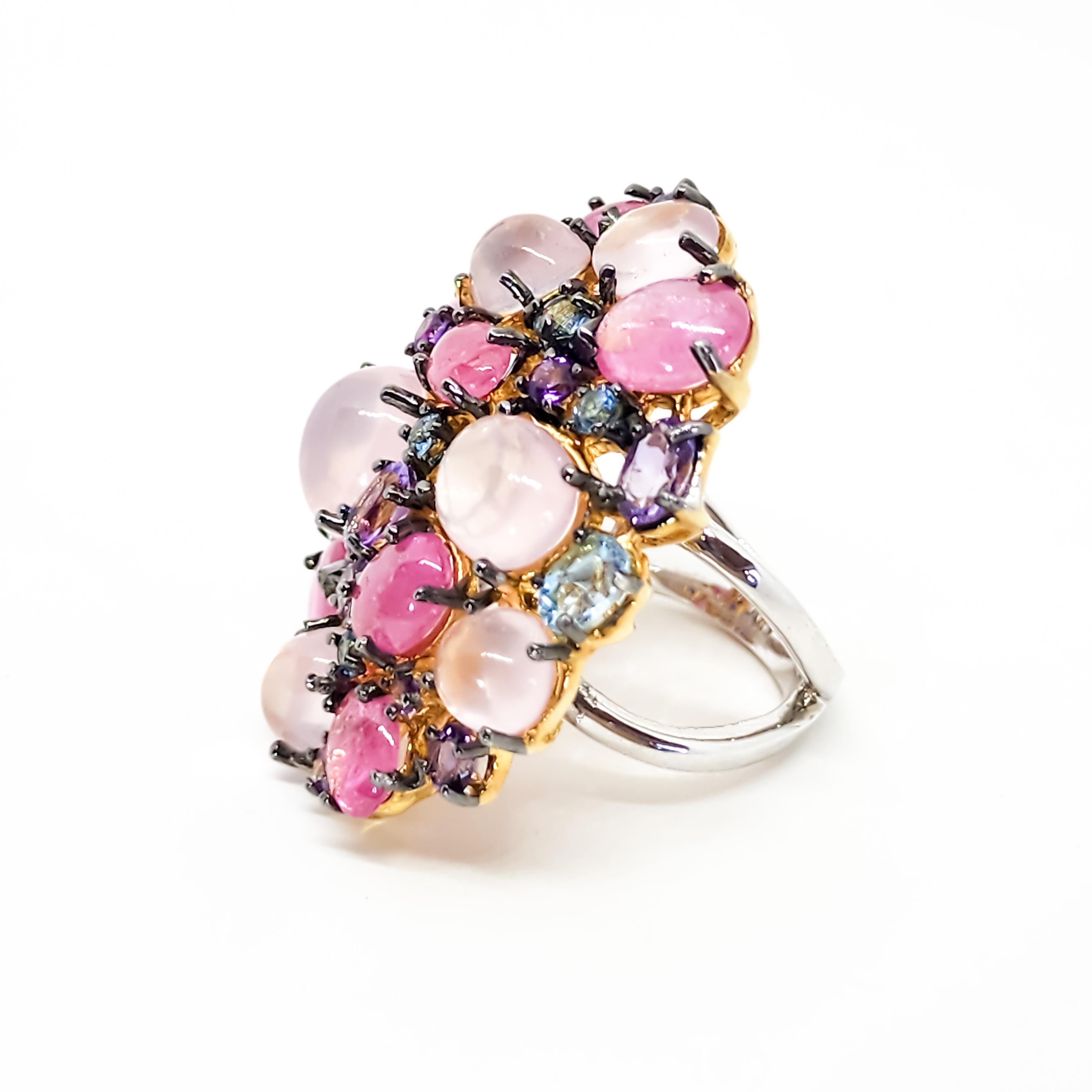 One large Cocktail, Cluster Ring featuring a Deliciously Sweet Confectionery of Colored Gemstones in Pinks, Blues and Purples. This festive Ring is an appropriate accent for all seasons wear.  The Large face of the Ring is an offset Oval of Color