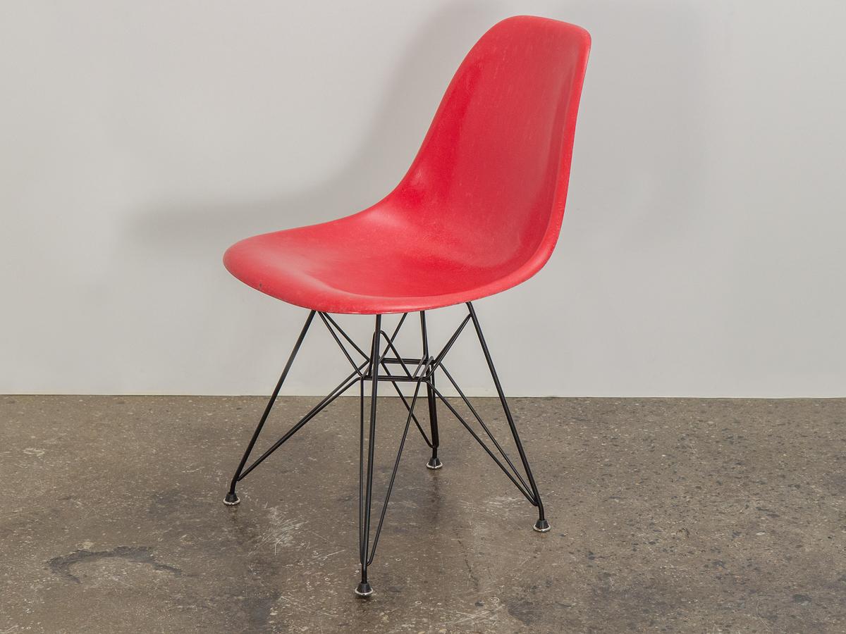 Original 1960s red fiberglass shell side chair designed by Charles and Ray Eames for Herman Miller. The scarce candy red colored shell has its original finish with distinct thread texture. Available as shown — mounted on a new Eiffel base.