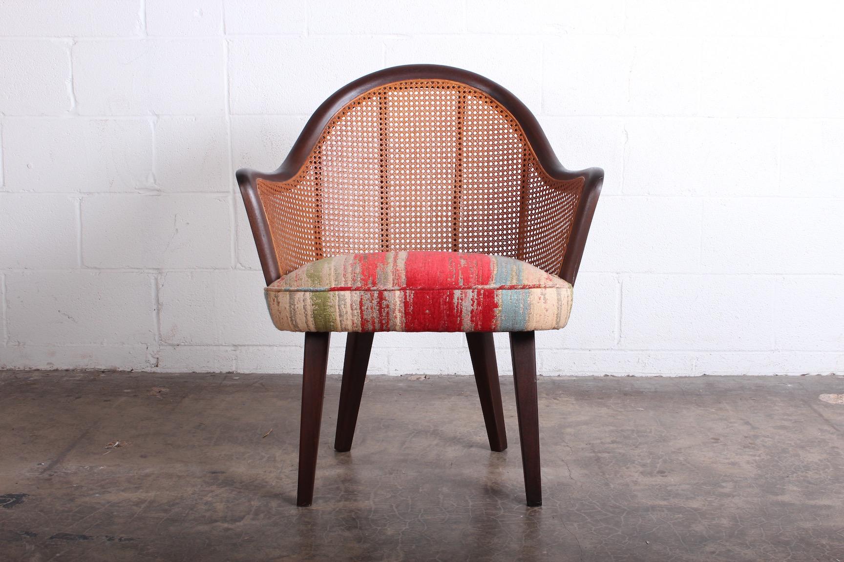 A mahogany and cane armchair attributed to Harvey Probber.