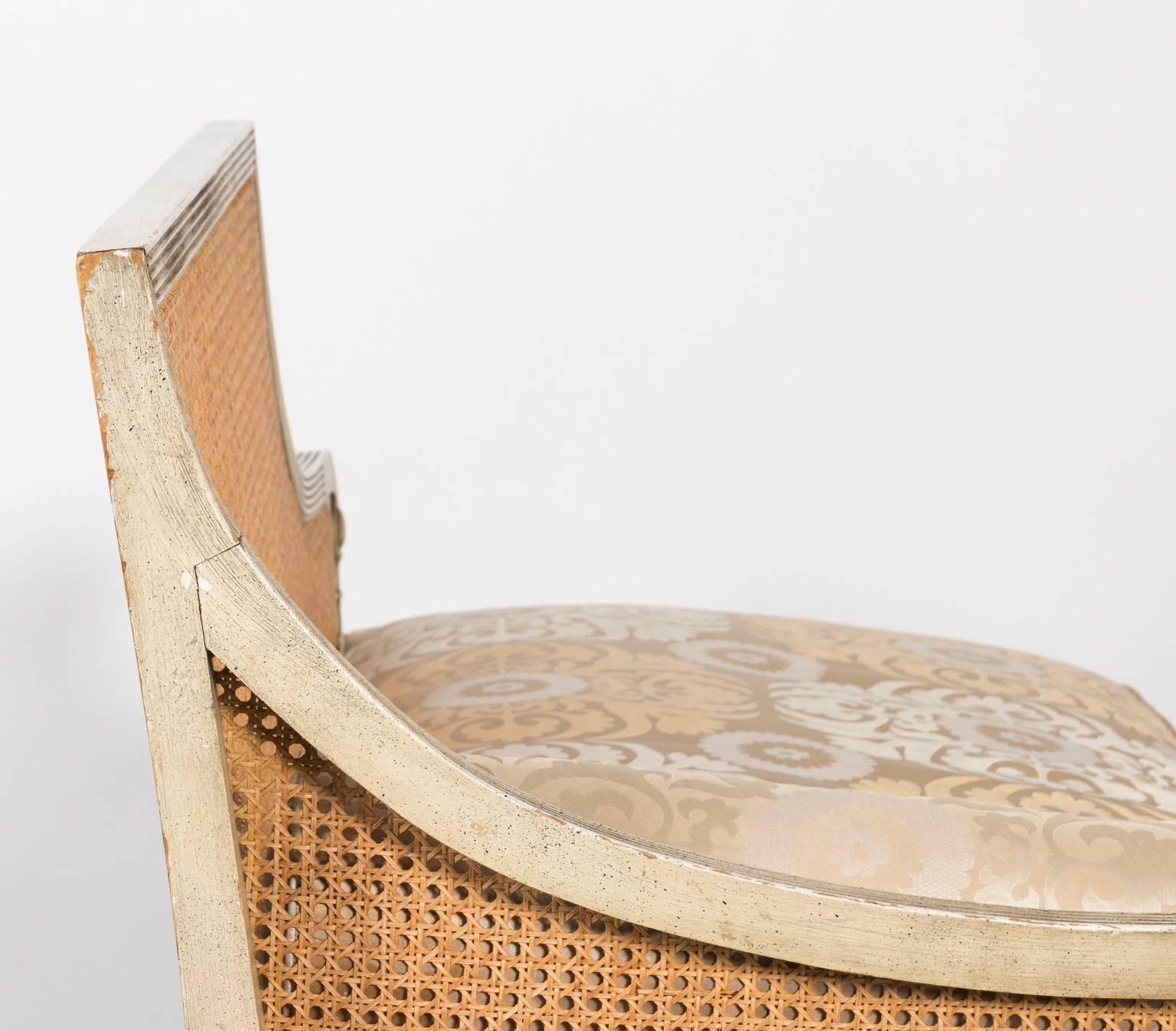 Bench in Manuel Canovas fabric with a woven cane back and wood in a distressed finish, circa 1960s.
 