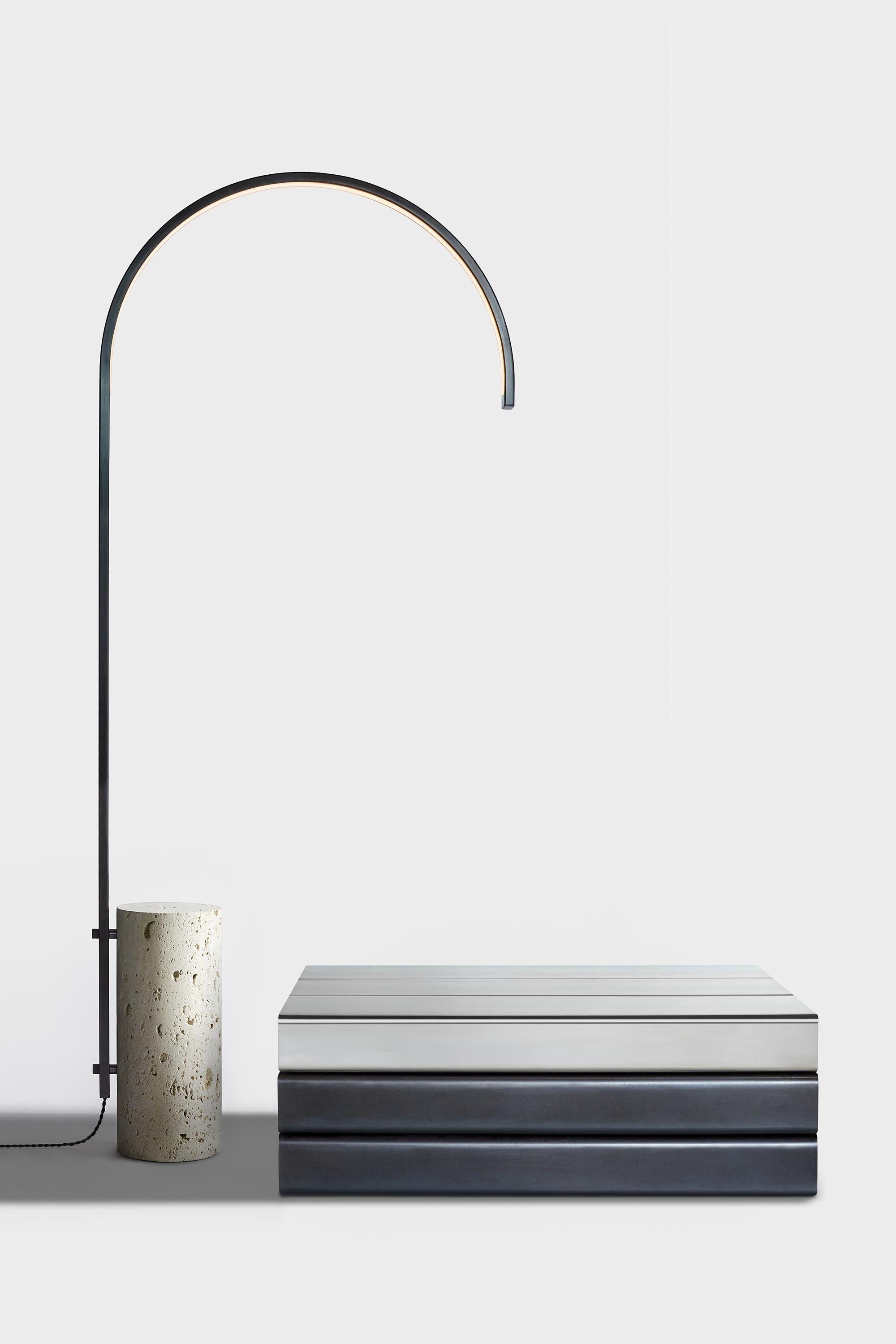The cane floor lamp, the first freestanding light by AlexAllen Studio, carefully balances the physical mass of its limestone base with the light, elegant curve of its illuminated stem. 

Available in four finishes: Bronze, mottled brass, gunmetal,