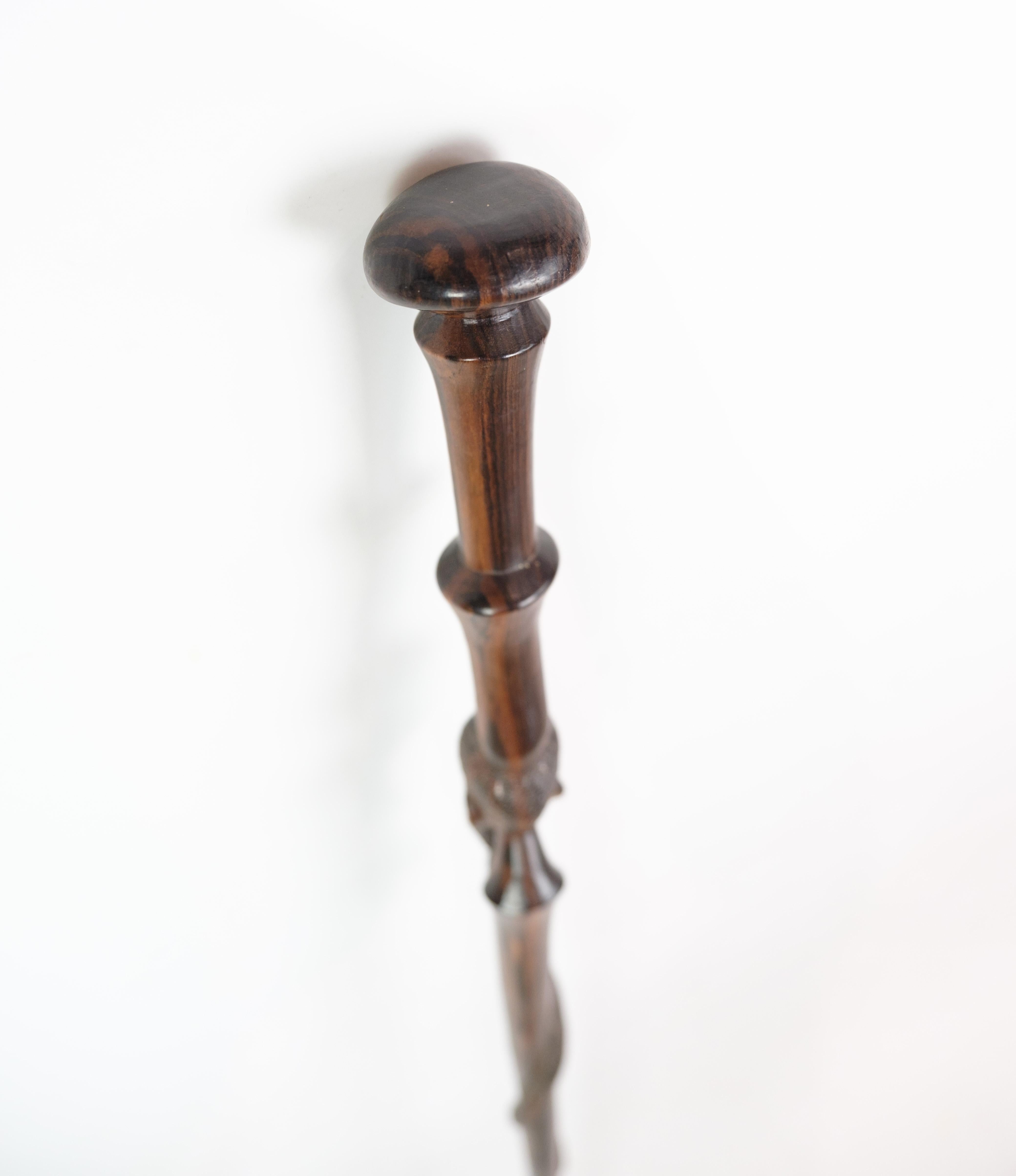 Cane in rosewood with a carved motif of a man being bitten by a snake 1960 For Sale 6