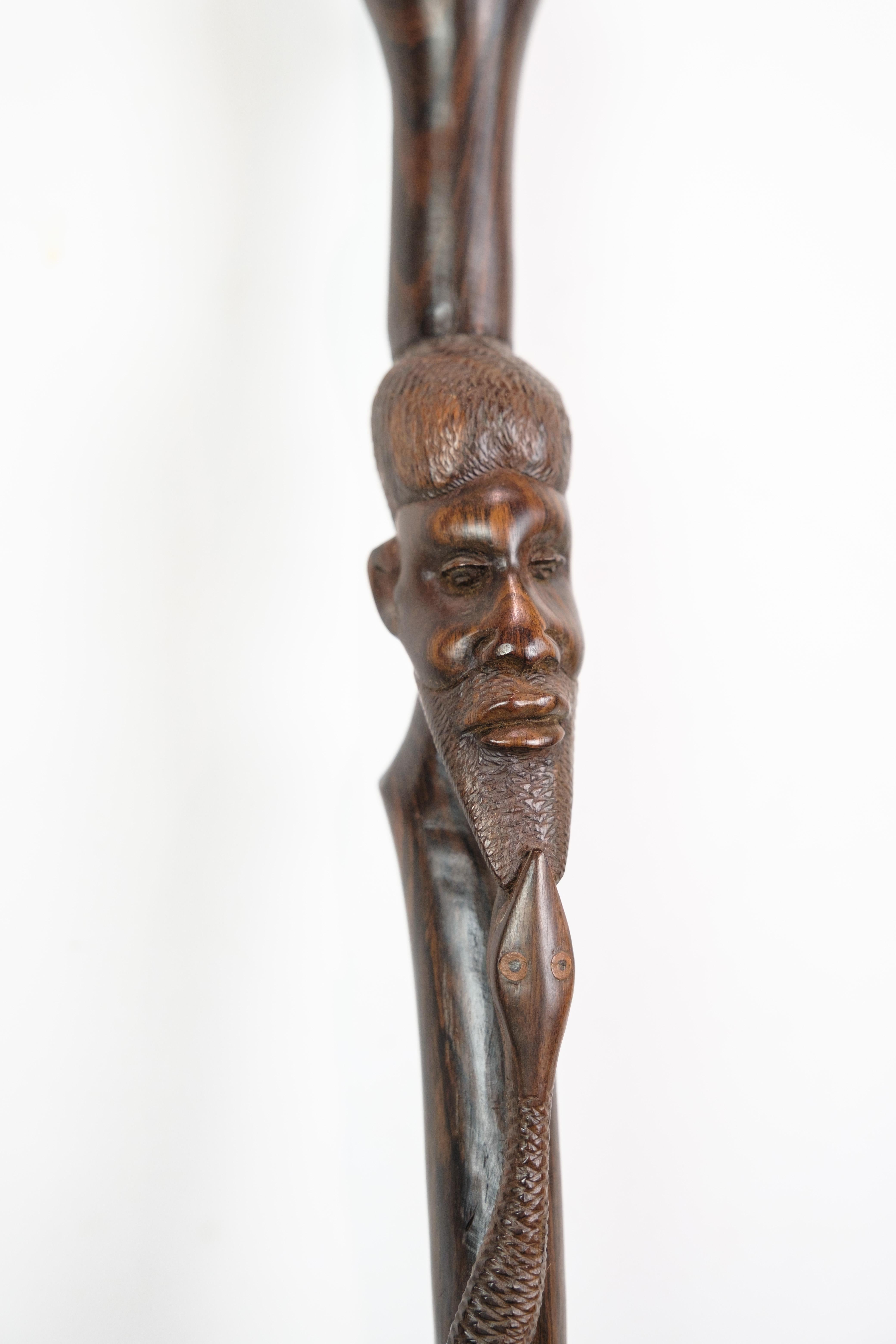 Cane in rosewood with a carved motif of a man being bitten by a snake 1960 For Sale 8