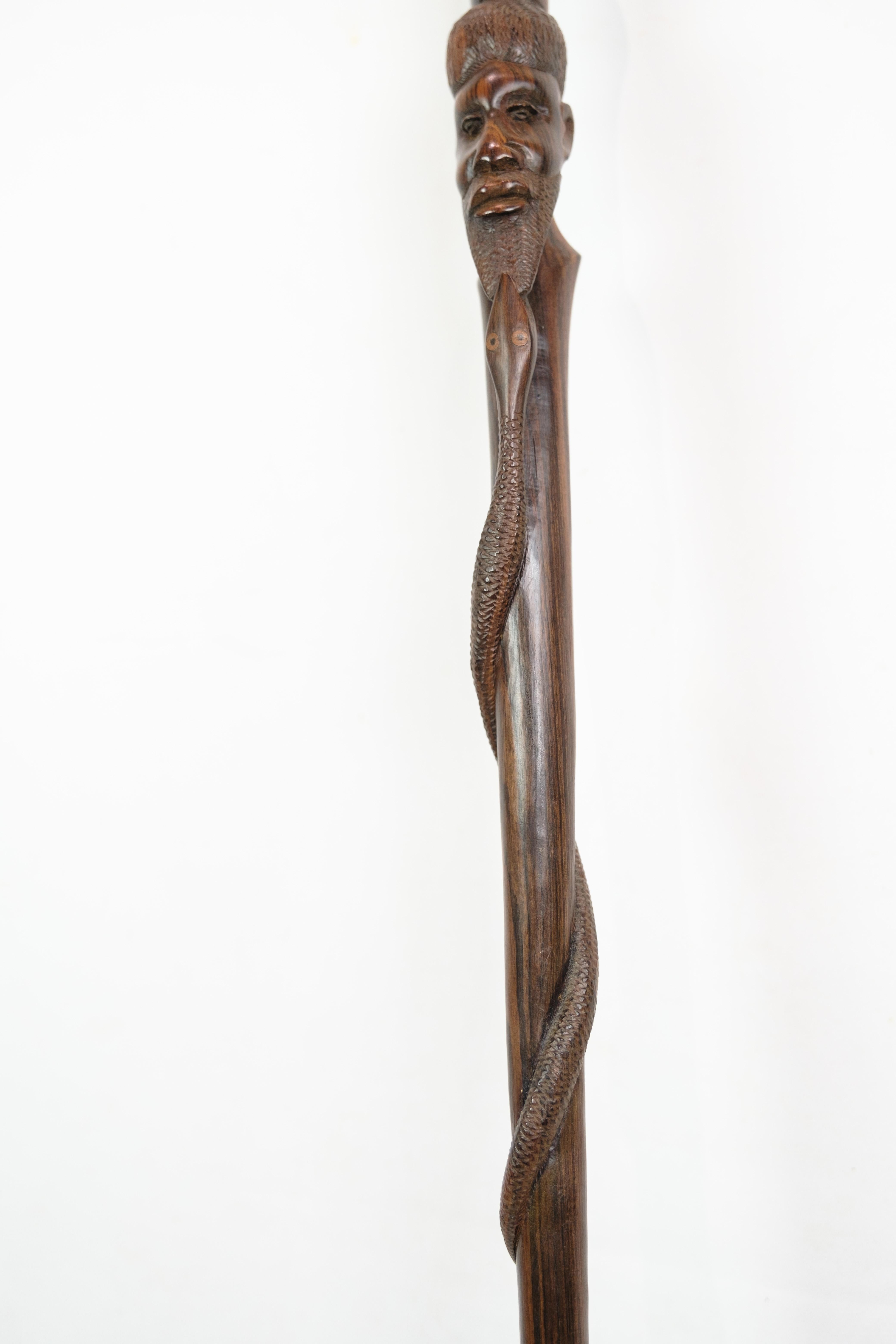Mid-20th Century Cane in rosewood with a carved motif of a man being bitten by a snake 1960 For Sale