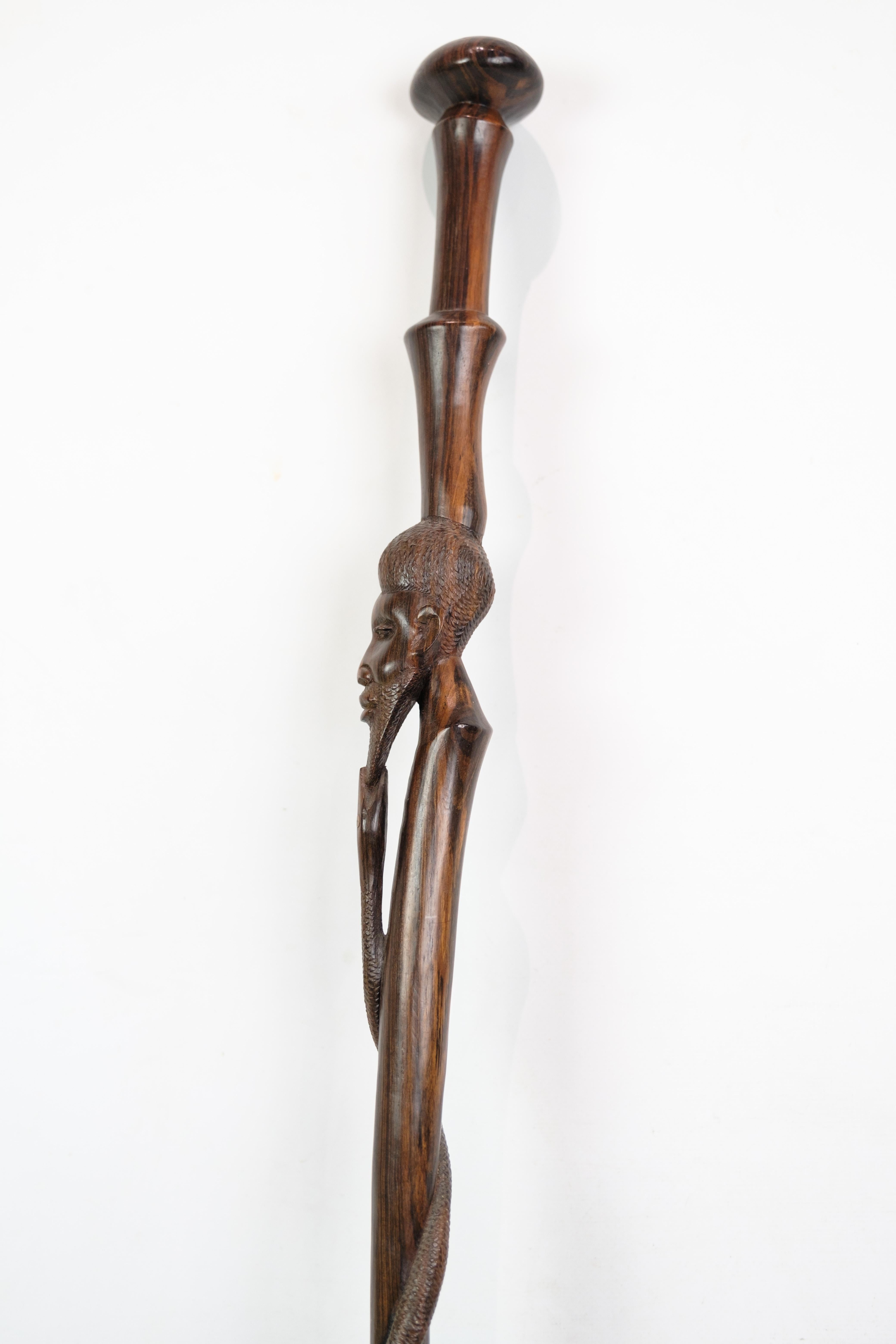 Rosewood Cane in rosewood with a carved motif of a man being bitten by a snake 1960 For Sale