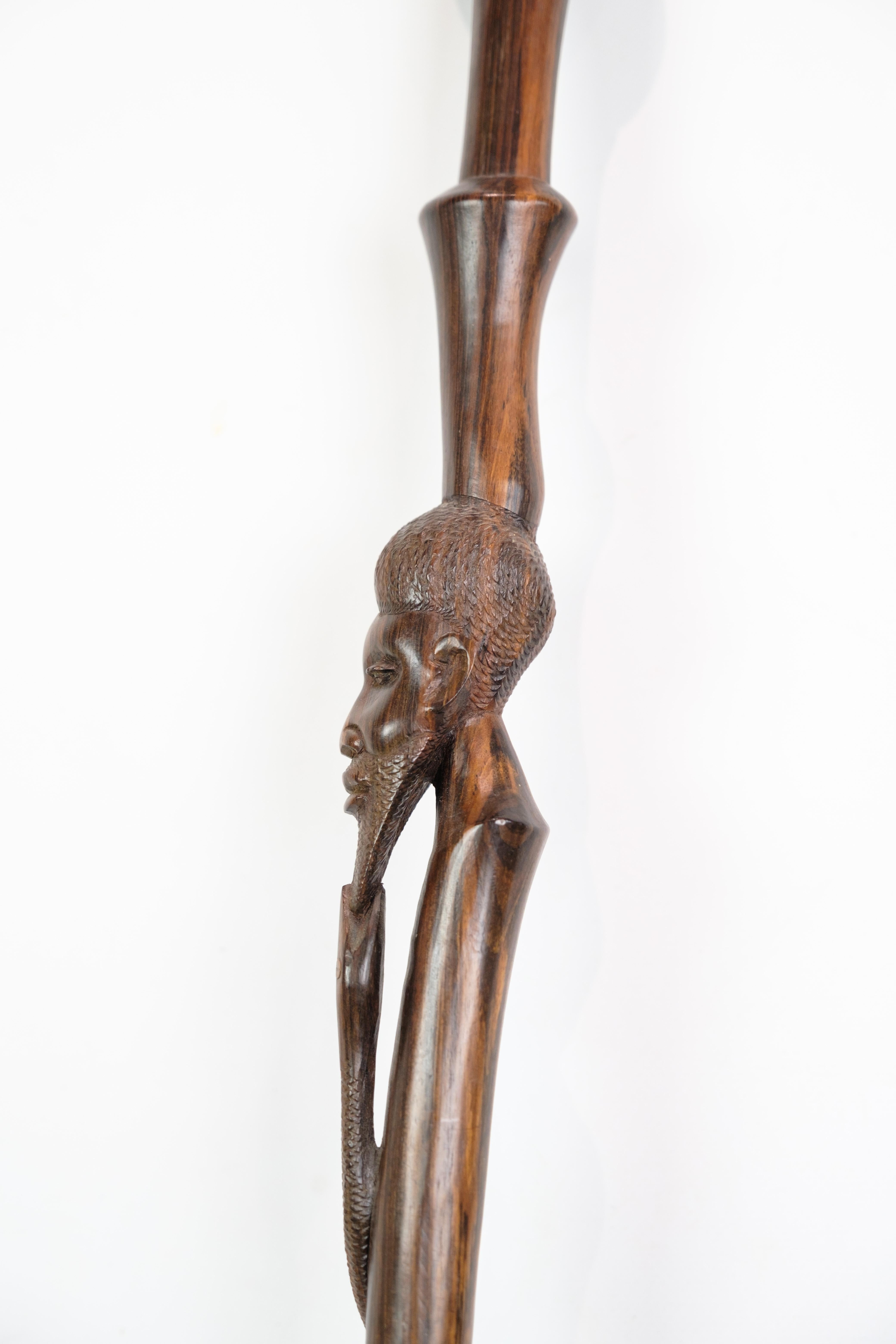 Cane in rosewood with a carved motif of a man being bitten by a snake 1960 For Sale 1