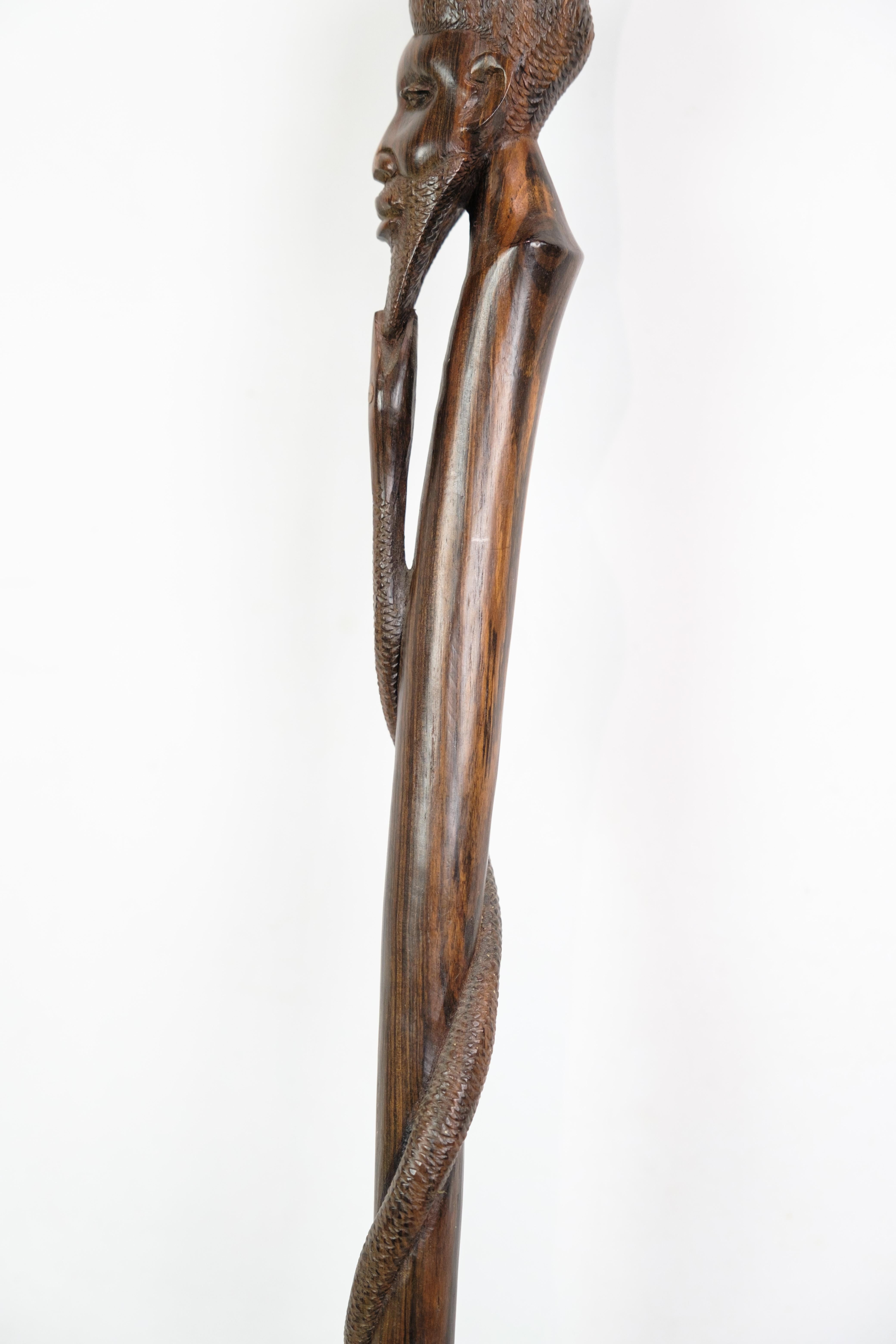 Cane in rosewood with a carved motif of a man being bitten by a snake 1960 For Sale 2