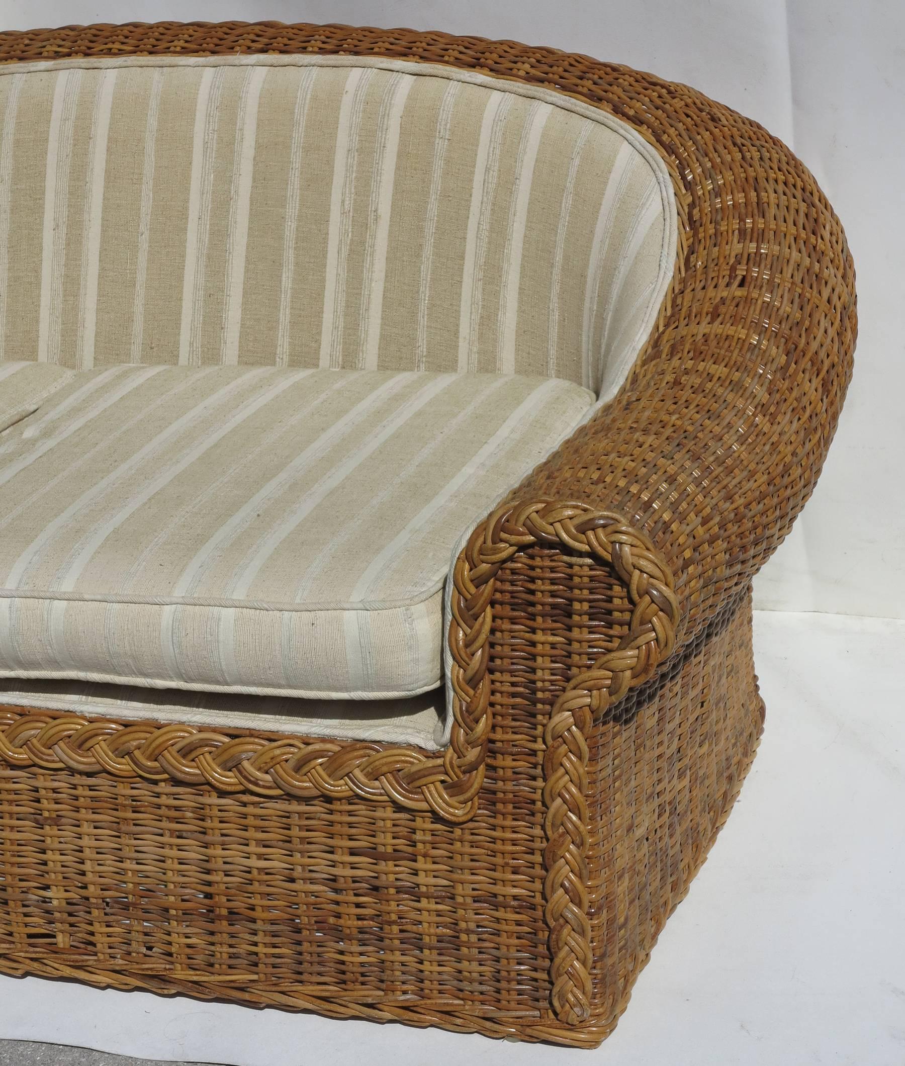 Small Sofa or Loveseat wicker and cane over a mahogany frame. Made in the Philippines for rattan works of Atlanta. Frame and caning in very good condition.