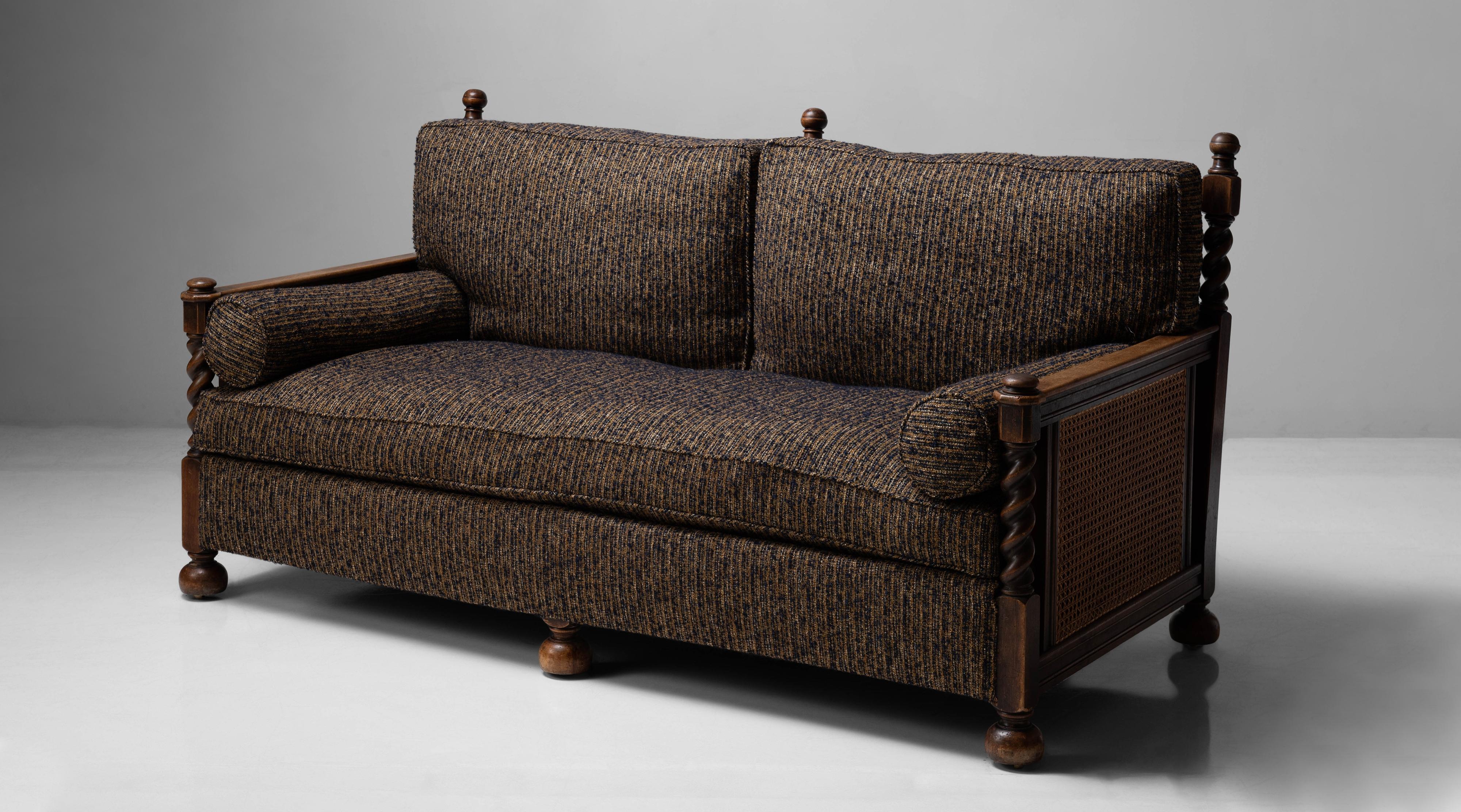 Newly upholstered cushions, oak and hardwood frame with spiral carving and cane sides and back.


Measures: 72.5