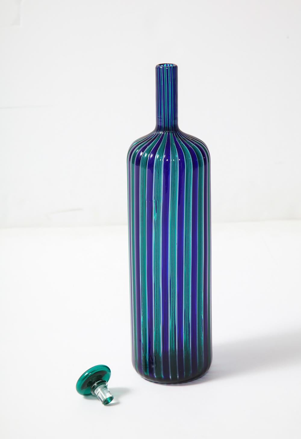 Blown glass bottle form created with canes of blue & green colors.