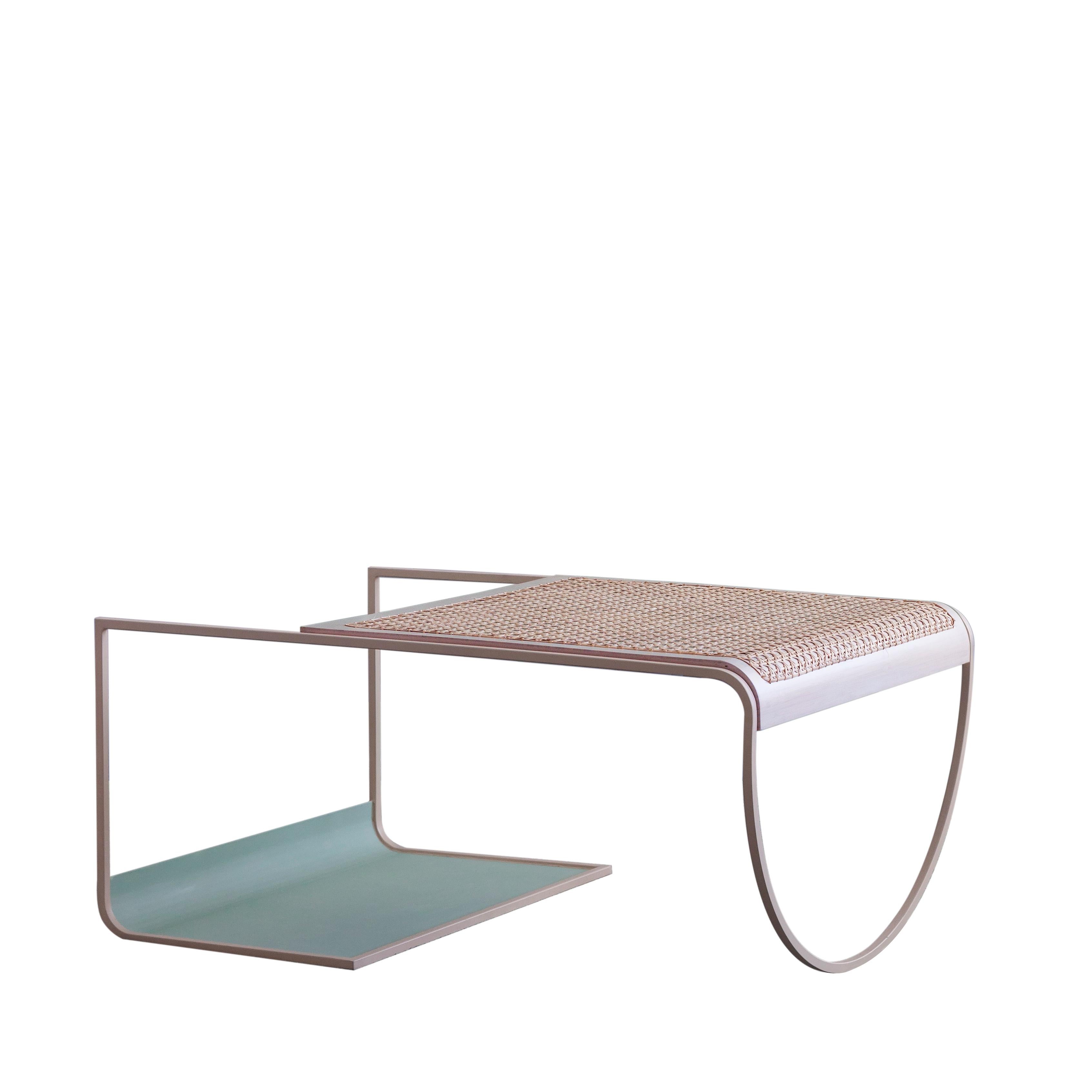 Cane SW coffee table by soft-geometry
Materials: Steel, handwoven cane
Dimensions: 36 x 24.5 x 17” H 

Simple, playful geometries form the light and fluid sw cane coffee table. The table perched on an arched-belly base on one side and a rolled rack