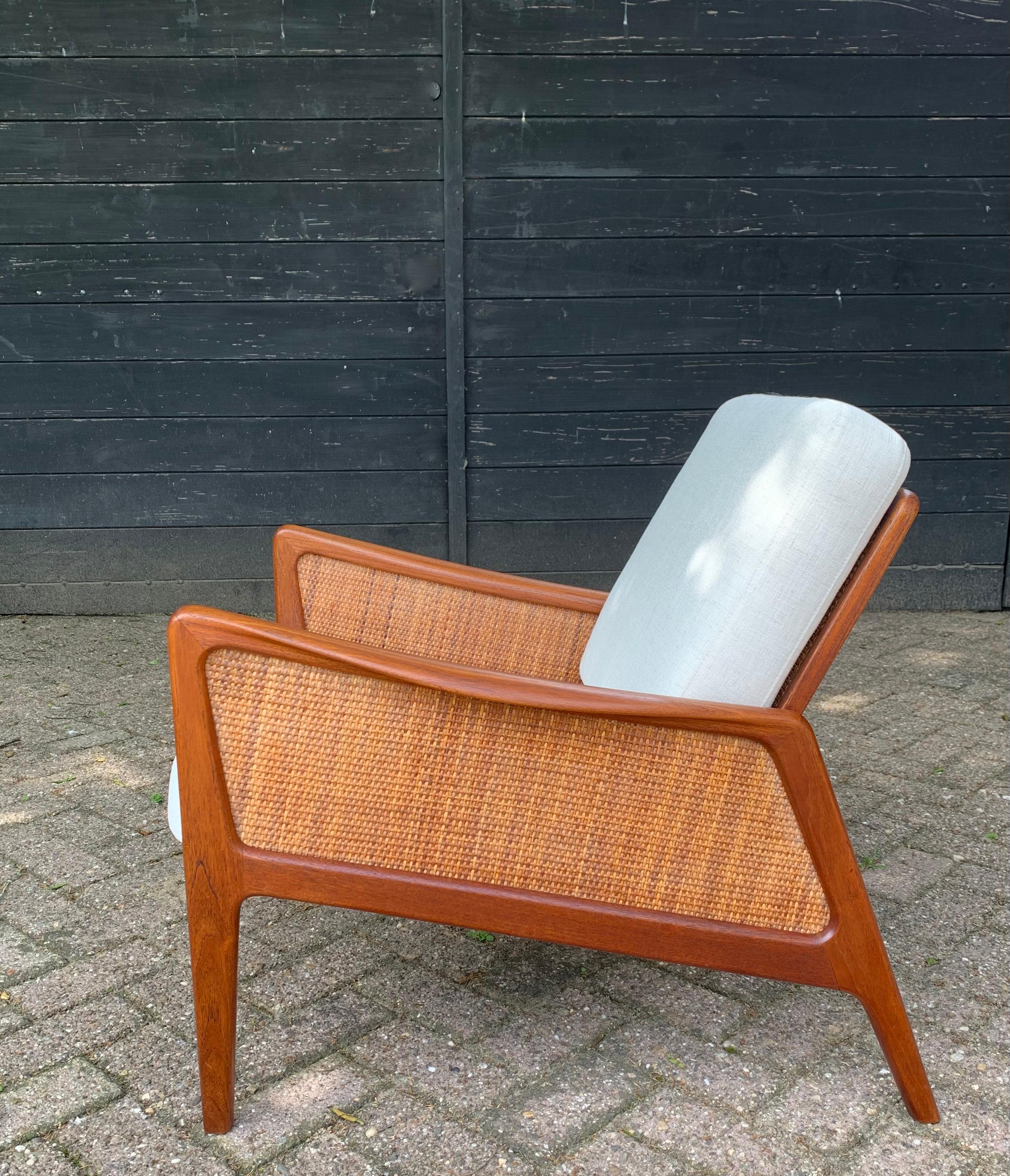Teak & cane lounge chair designed by Danish designers Peter Hvidt & Orla Mølgaard-Nielsen. This renowned designer duo has stood side by side for over 30 years, designing many famous and intrinsic designs. Amongst this beautiful lounge chair model