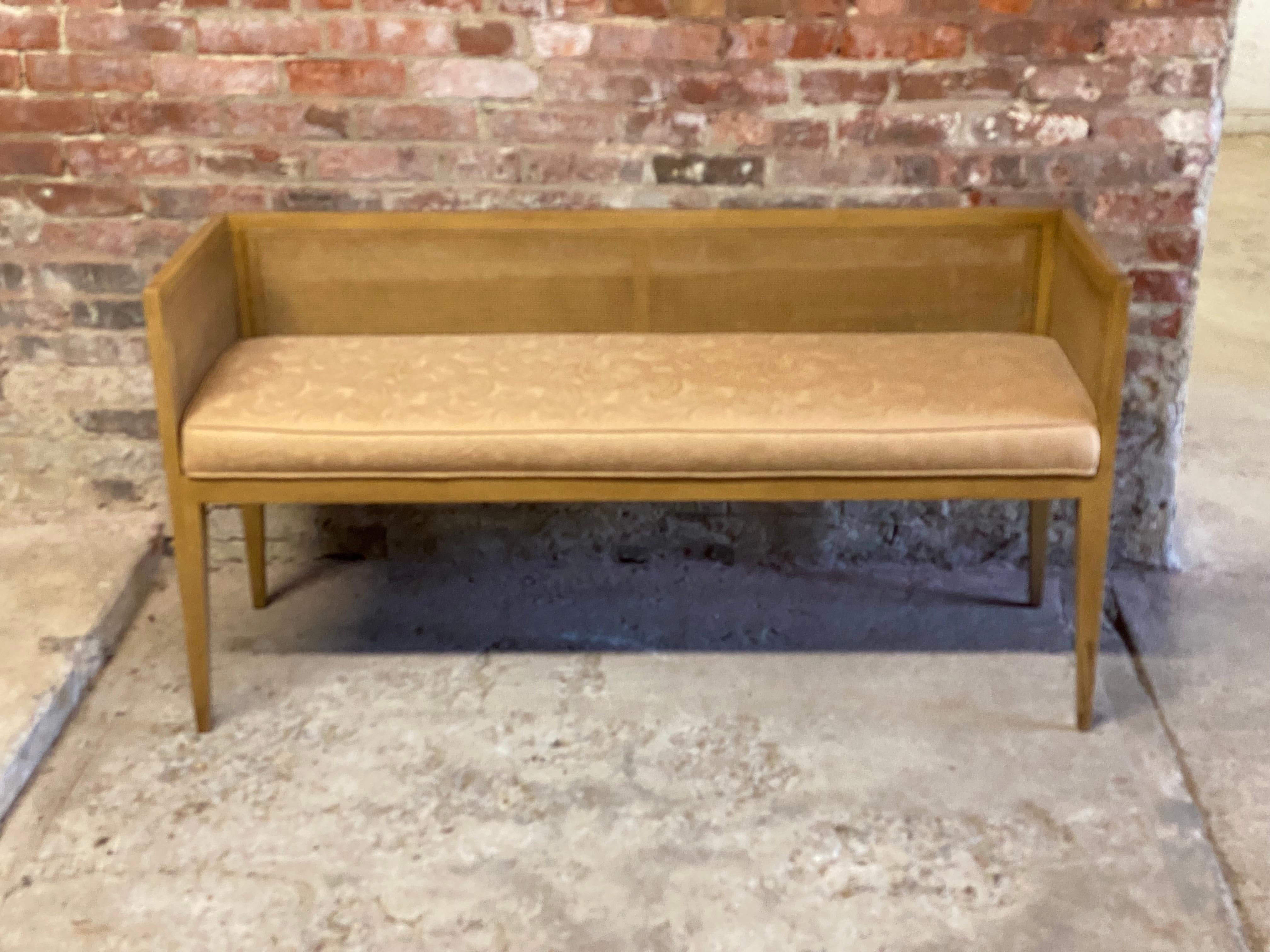 Mid-Century Modern mahogany and caned bench. The perfect seating solution for anywhere in the home or office. Placed at the foot of the bed, foyer, window seat or waiting room. The bench features solid mahogany construction, with caned back and side