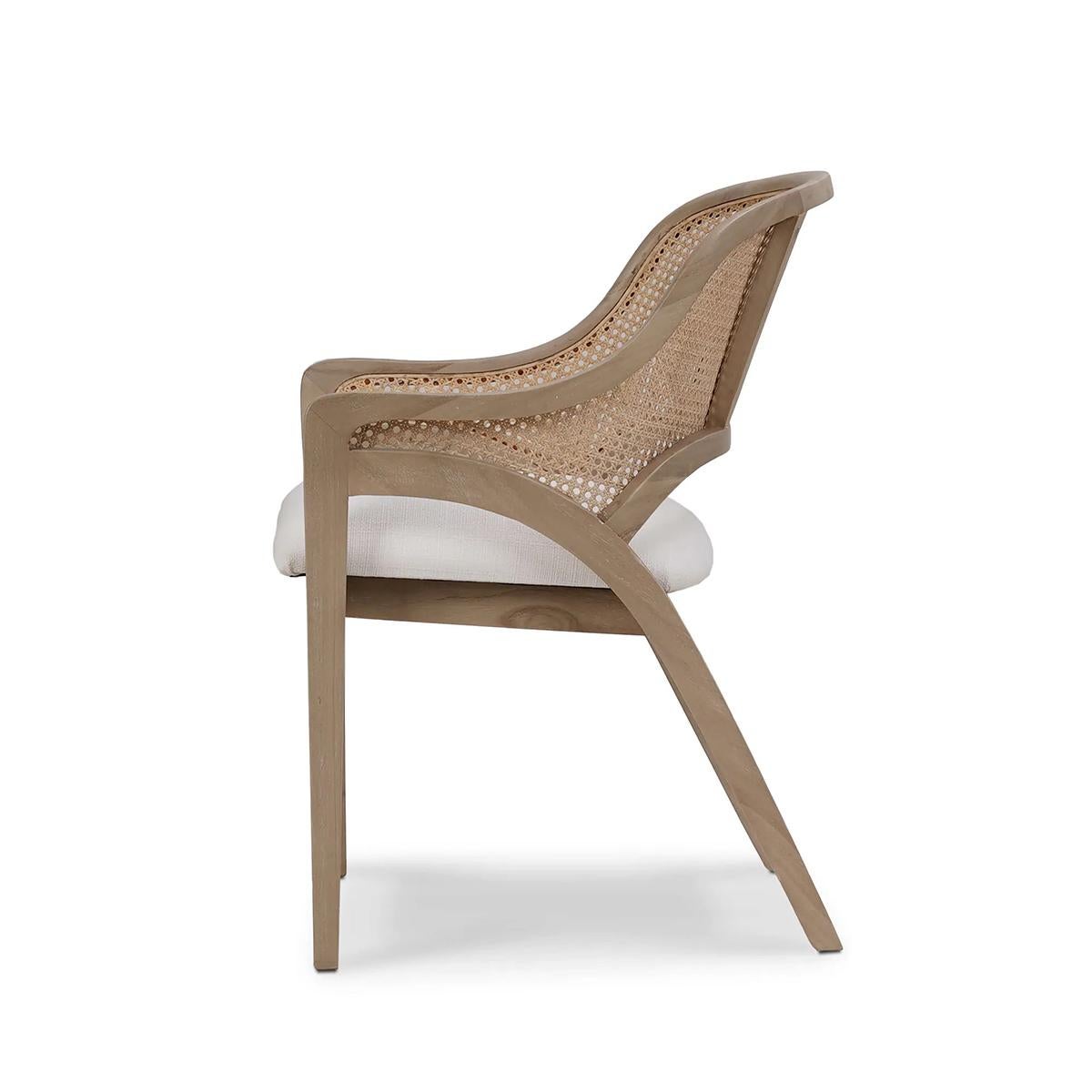 This armchair features a beautifully crafted natural rattan caned back, offering both style and support, while the rich Sandbar finish adds warmth and sophistication. The seat is topped with an Arctic White Performance Fabric cushion, designed for