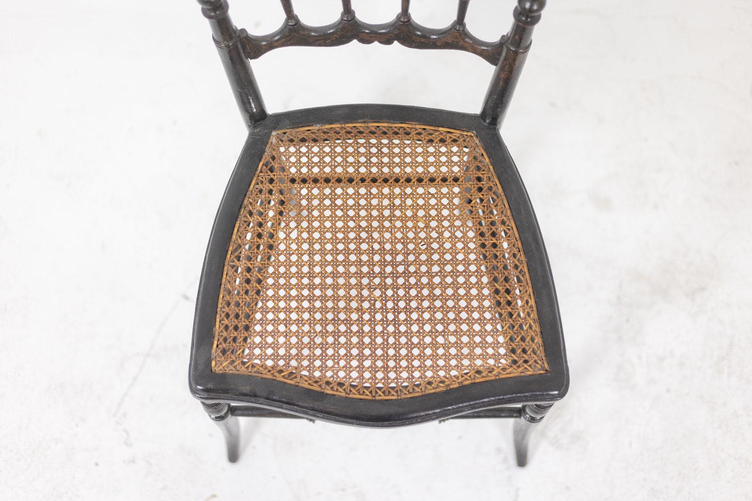 Chair in turned and blackened wood, the back with columns and the front legs as well as the spacer decorated with golden branches. Cane seat. French work from the Napoleon III period.


Patinated gilding. 

Reference: LS601257U
