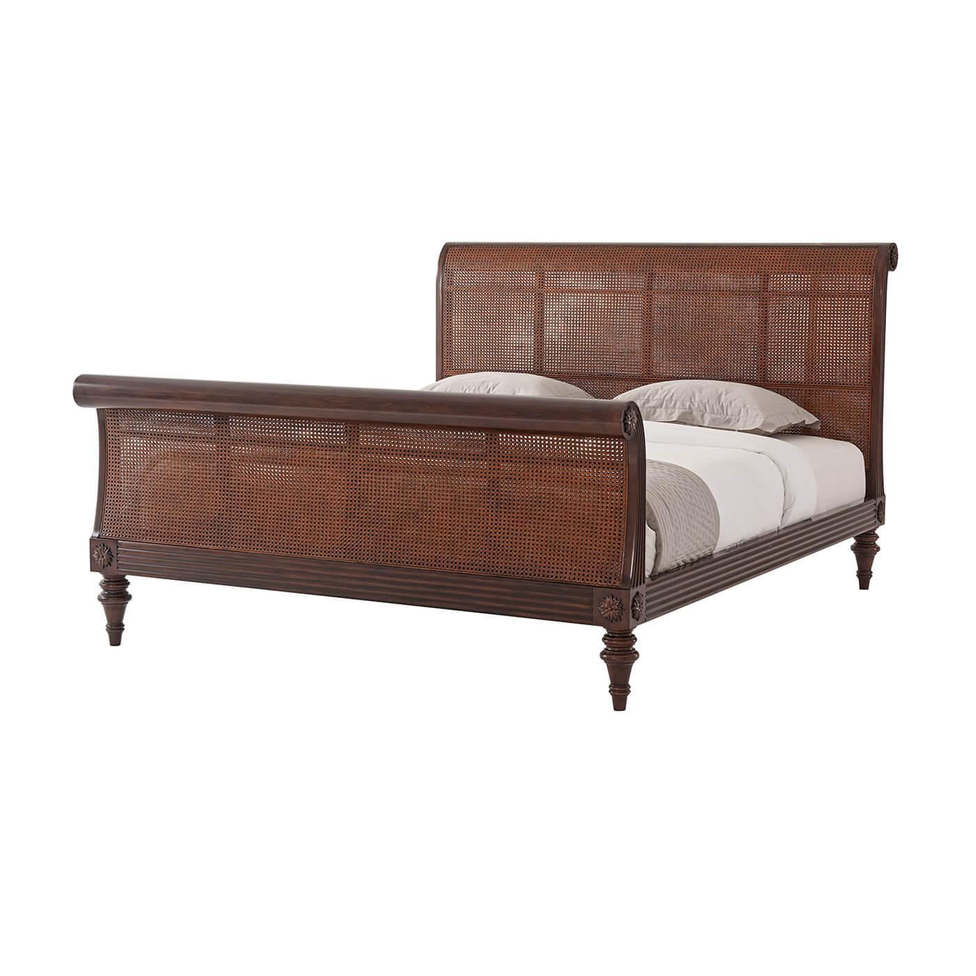 A Regency style Anglo-Indian bed. With a modestly scrolled headboard and footboard with caned panels. Reeded rails, flowerhead carved roundels, scroll carvings and turned tapered legs add authenticity and charm.

Shown in Cambridge Finish
For CAL.