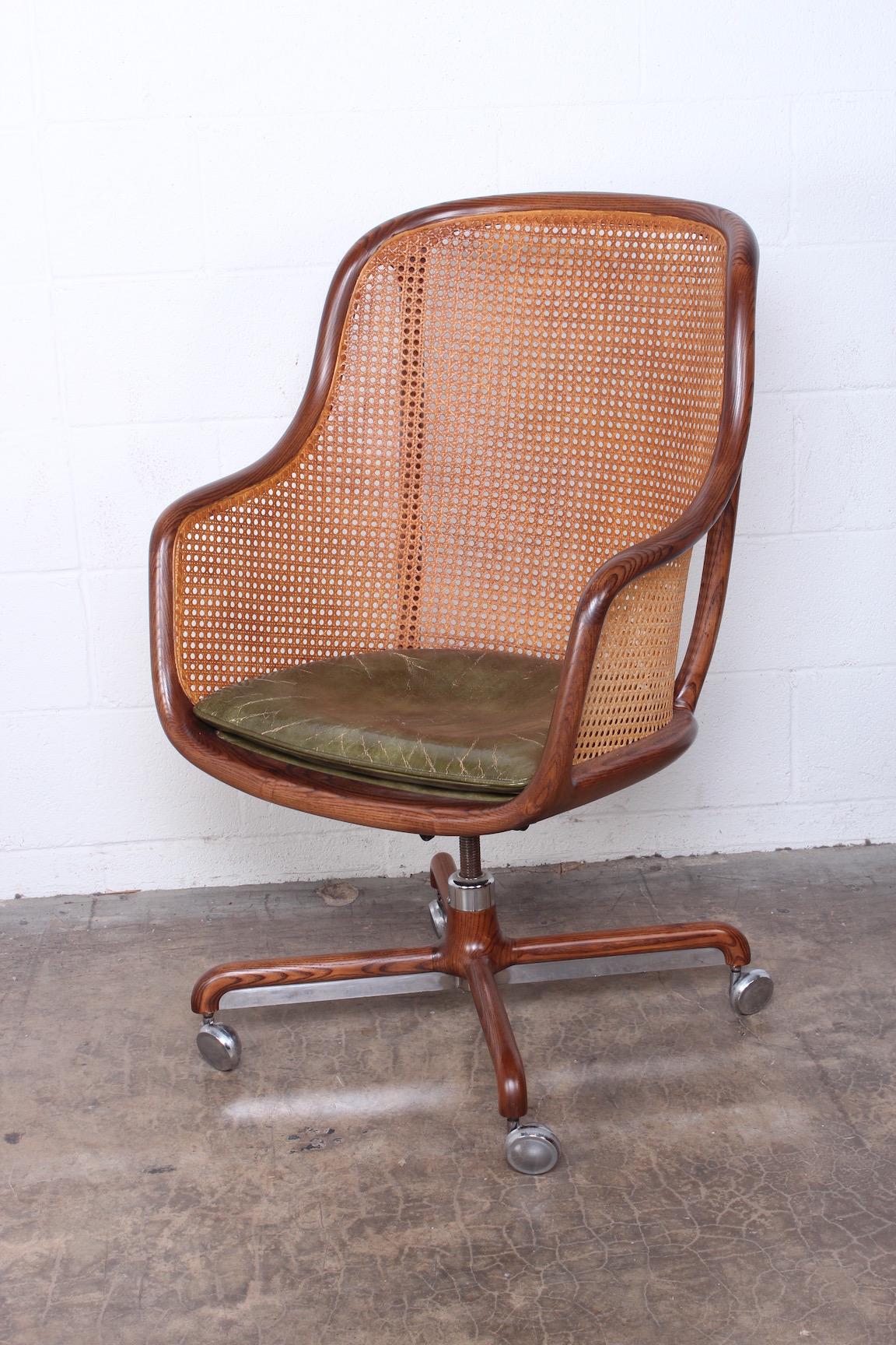 A fully caned desk chair with ash frame and original leather seat. Designed by Ward Bennett for Brickel.