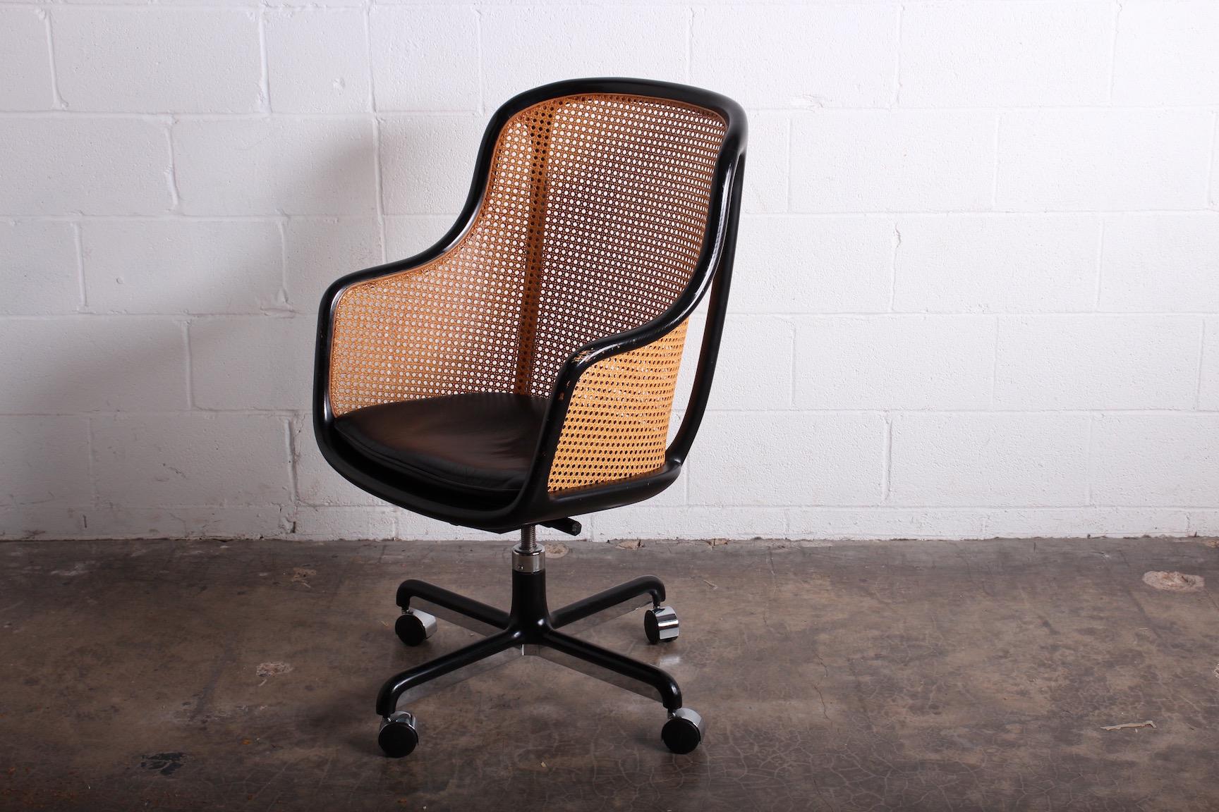 A fully caned desk chair with original black frame and original leather seat. Designed by Ward Bennett for Brickel.