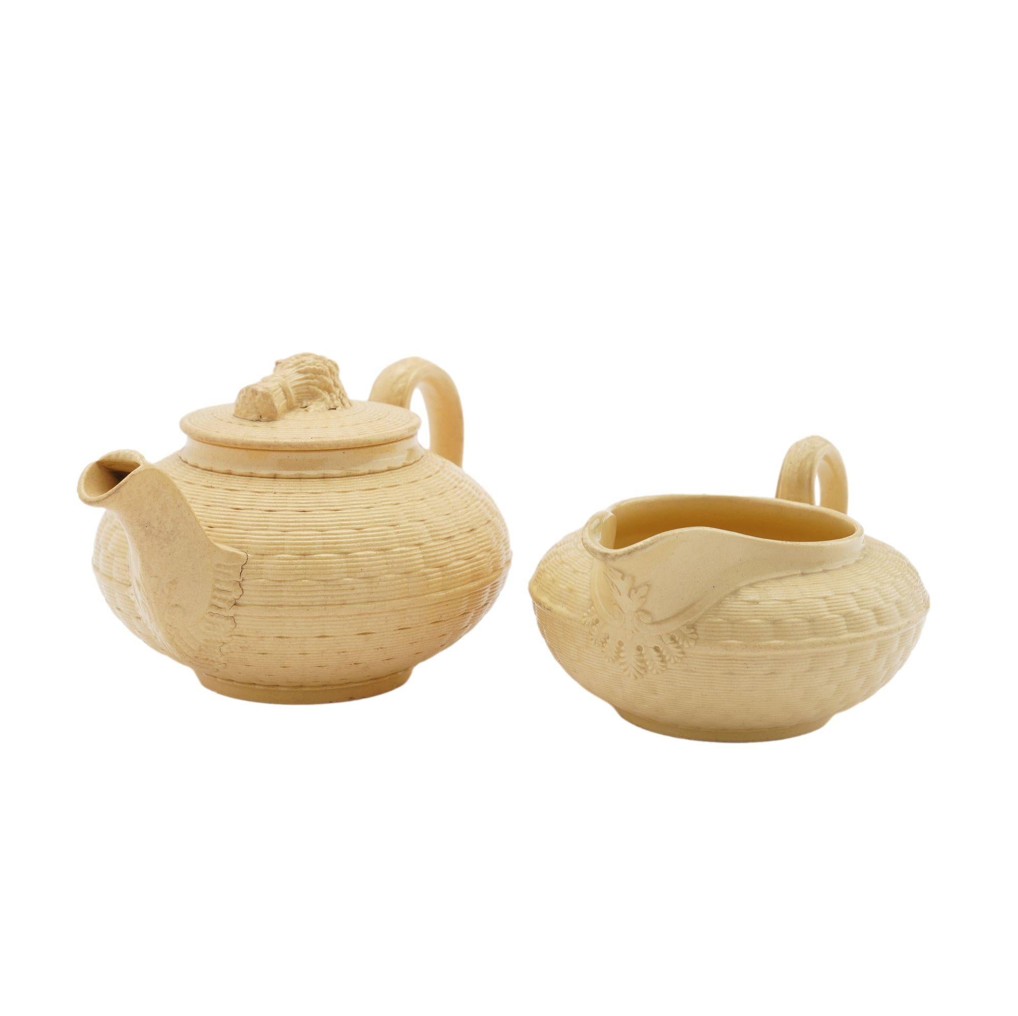 Caneware ceramic creamer with impressed basket weave surface decoration, along with matching teapot with lid finial in the form of a sheaf of wheat.
Impressed on the underside: Wedgwood

England, circa 1817.

Dimensions: Teapot: 5-3/4” L x 3-3/4” W