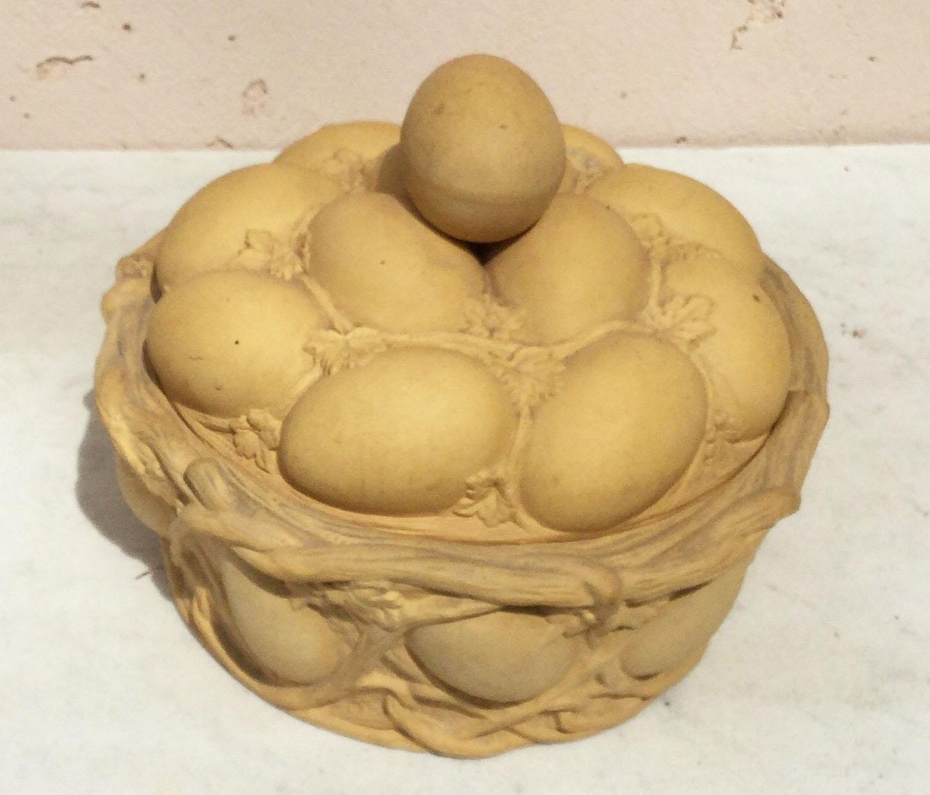 Continental Majolica-style caneware egg basket, circa 1880 signed Wilhelm Schiller and Sons.
Caneware is a type of unglazed, tan-colored stoneware, developed circa 1770 by Josiah Wedgwood.