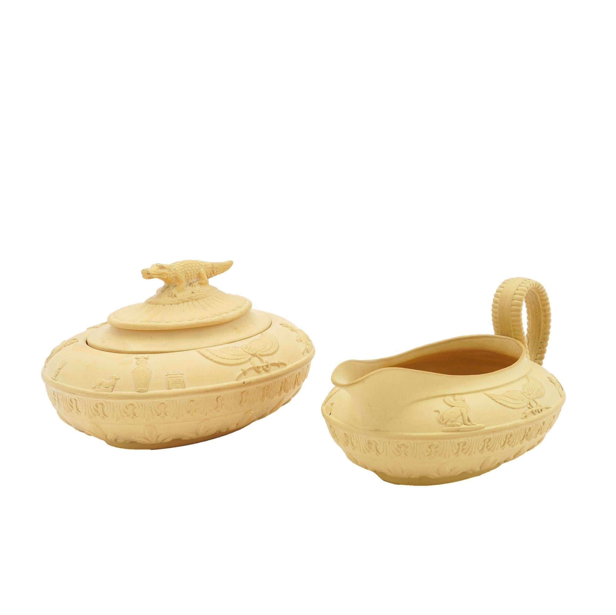 Bisque caneware creamer and covered sugar bowl in the Egyptian taste, highlighted by applied pseudo hieroglyphics and a crocodile finial on the sugar bowl. Produced in the Tetschen studio of Schiller & Gerbing, located in what is now the Czech