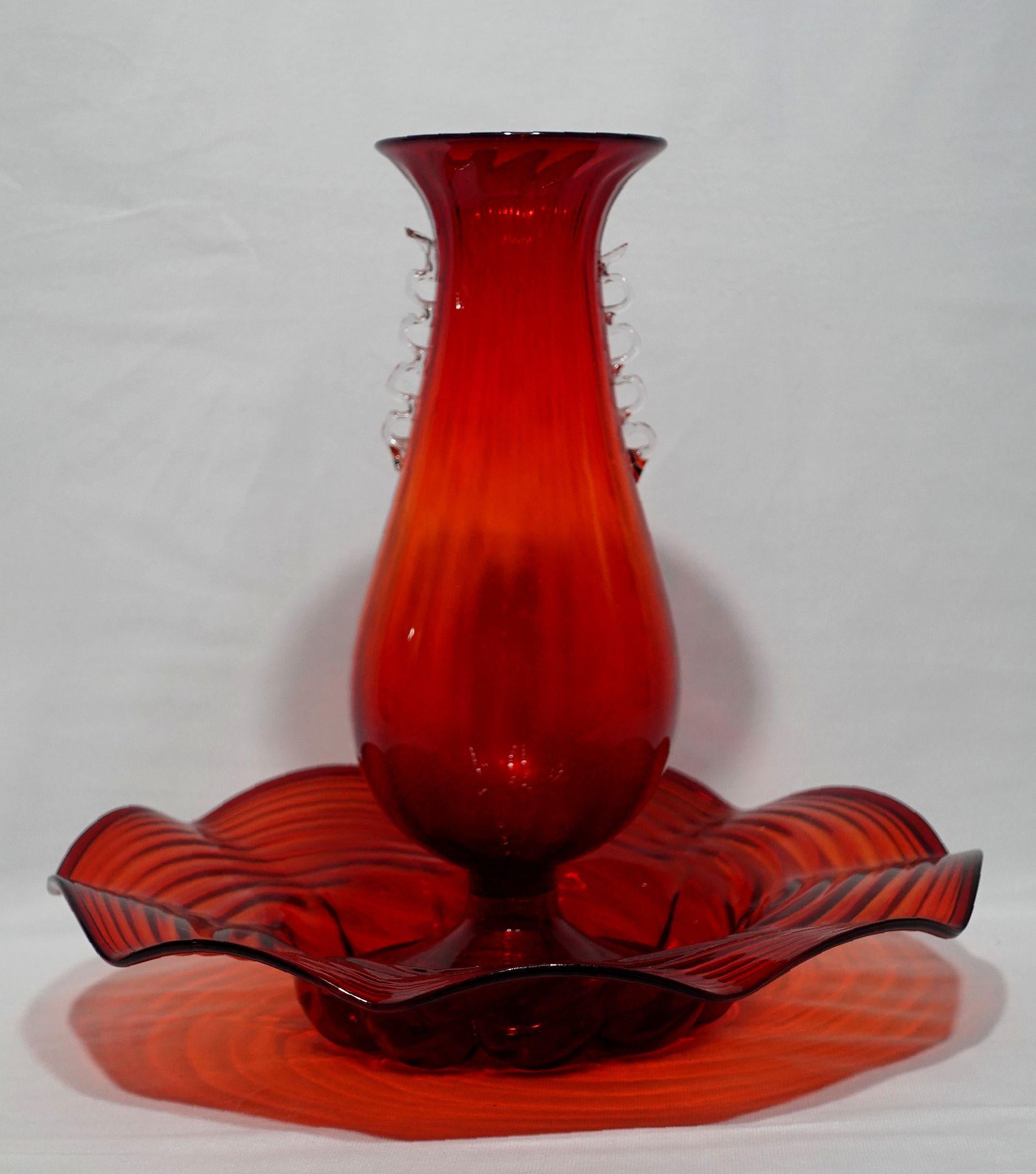 Cannellini Red Art Glass Vase and Center Bowl
vase with ribbon-form handle, on round feet, ht. 12, center bowl with scalloped rim, dia. 13 1/4 in.