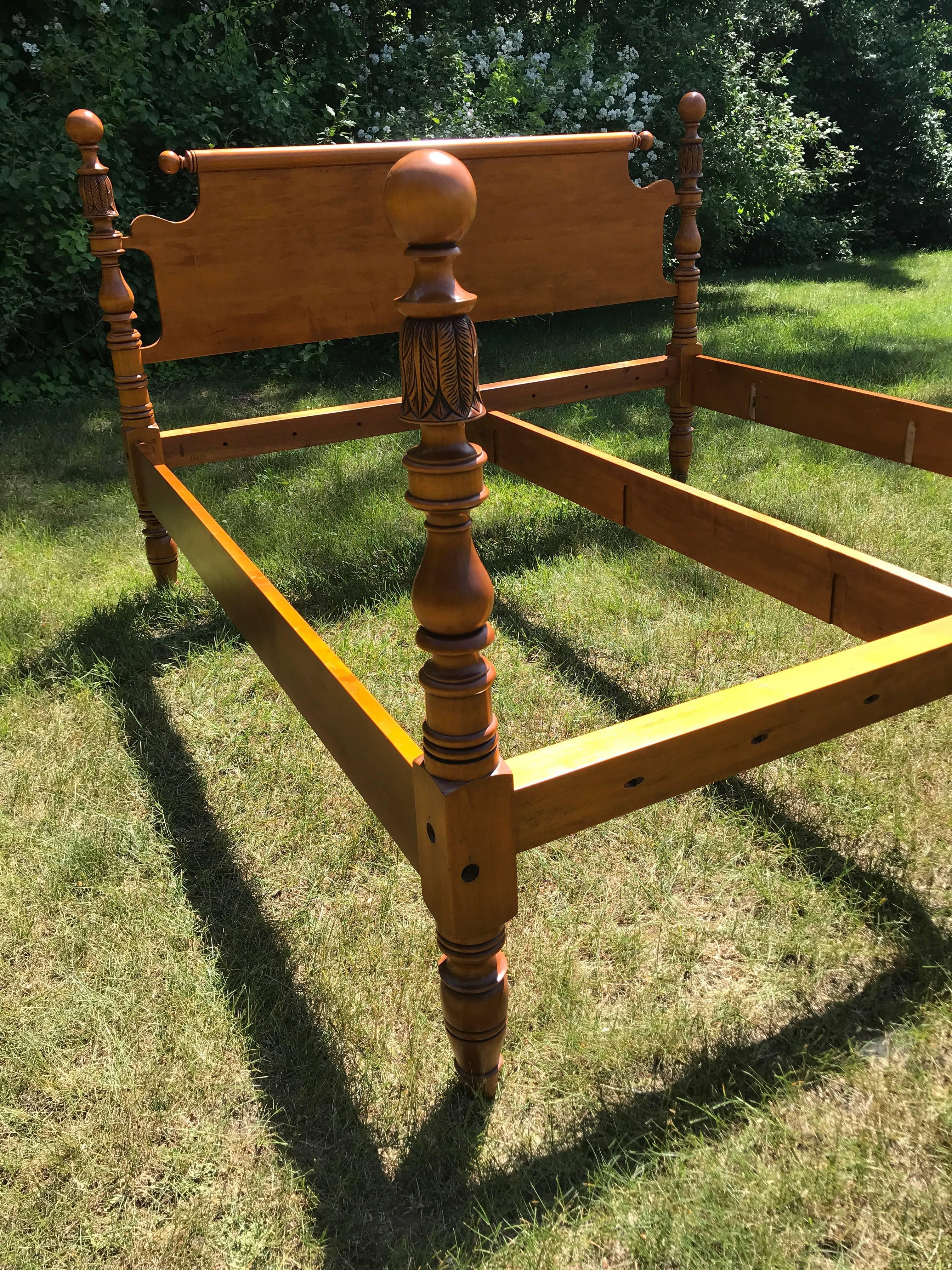 Reproduction king-size cannonball and feather carved bed in maple with roll top repeat end headboard. 

Measures: 82