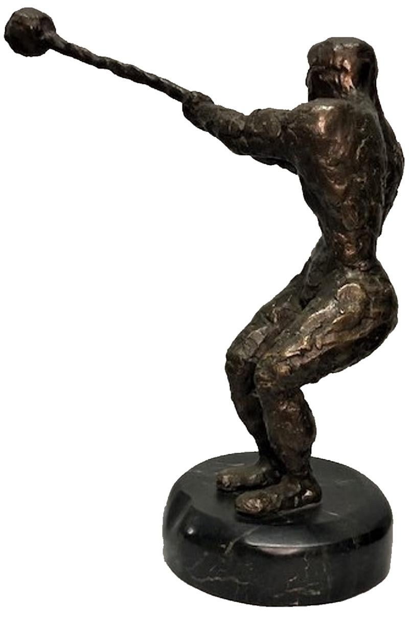 Definitely created by a master sculptor, this small but very dynamic modernist sculpture depicts a cannonball thrower in the moment of forceful rotation before the actual throw of the projectile.