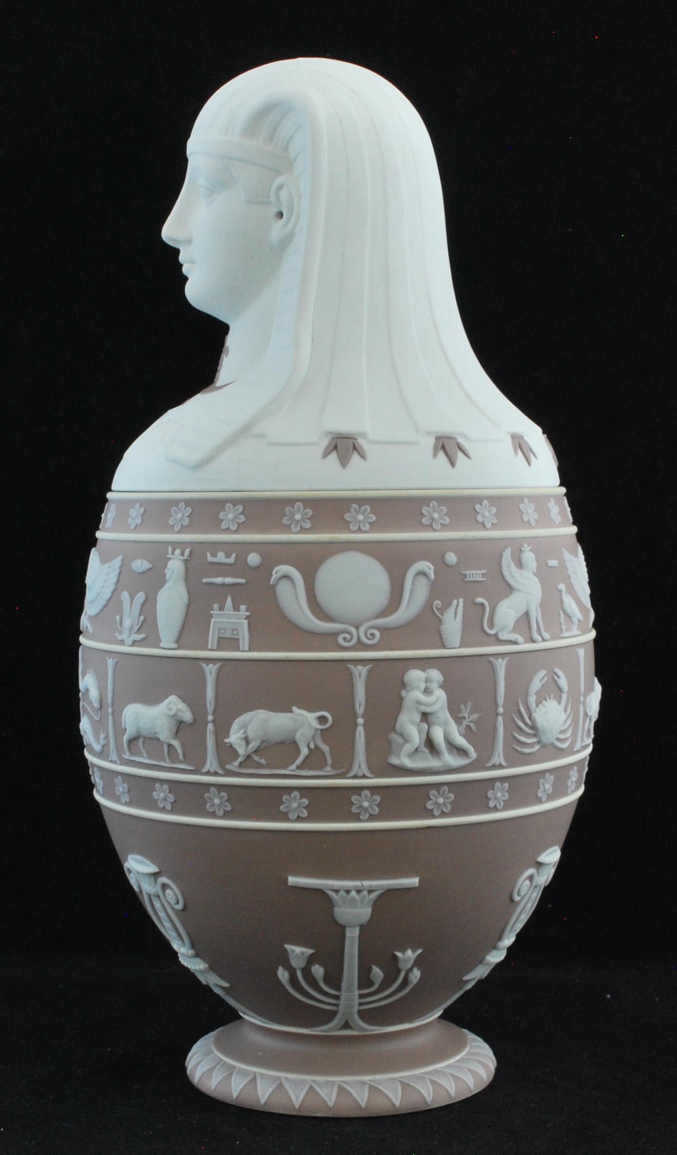 A superb canopic jar in lilac and white jasper, artfully combining features and pseudo-hieroglyphs taken from D’Hancarville’s Antiquities.

These were produced by Wedgwood from time to time, in response to public interest in things Egyptian. There